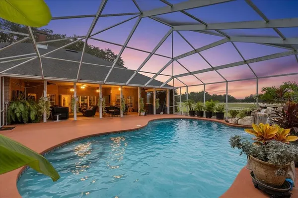 a kitchen with stainless steel appliances granite countertop a sink a stove and cabinets