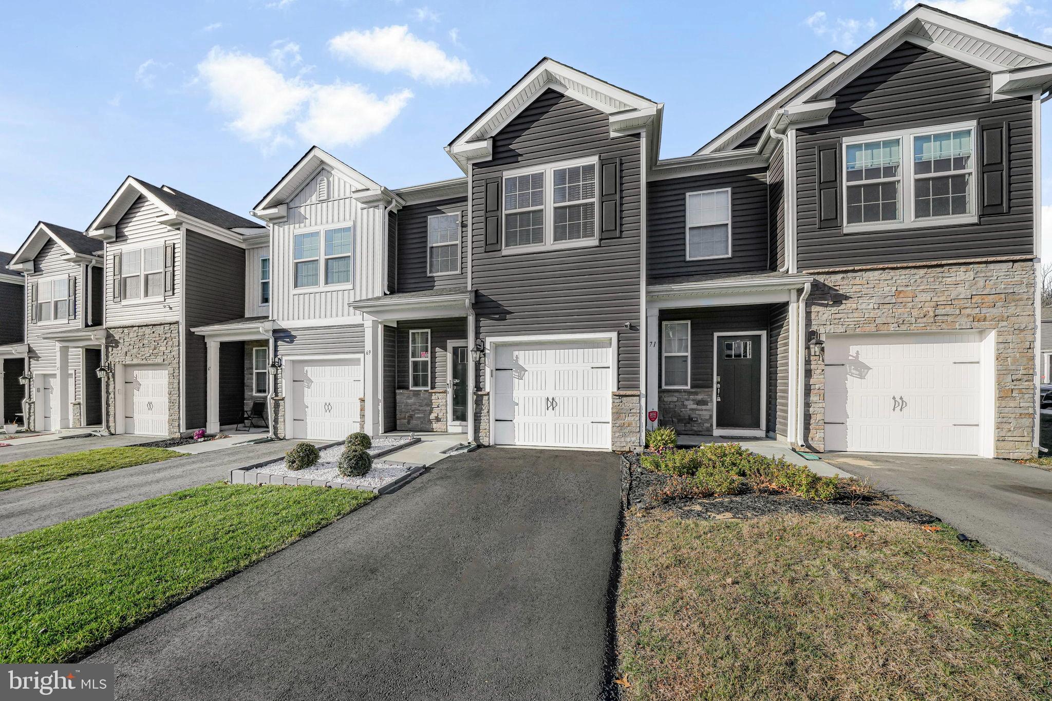 69 Peregrine Way Burlington, NJ 08016 - Photo 2 of 28 a front view of a house with a yard and garage