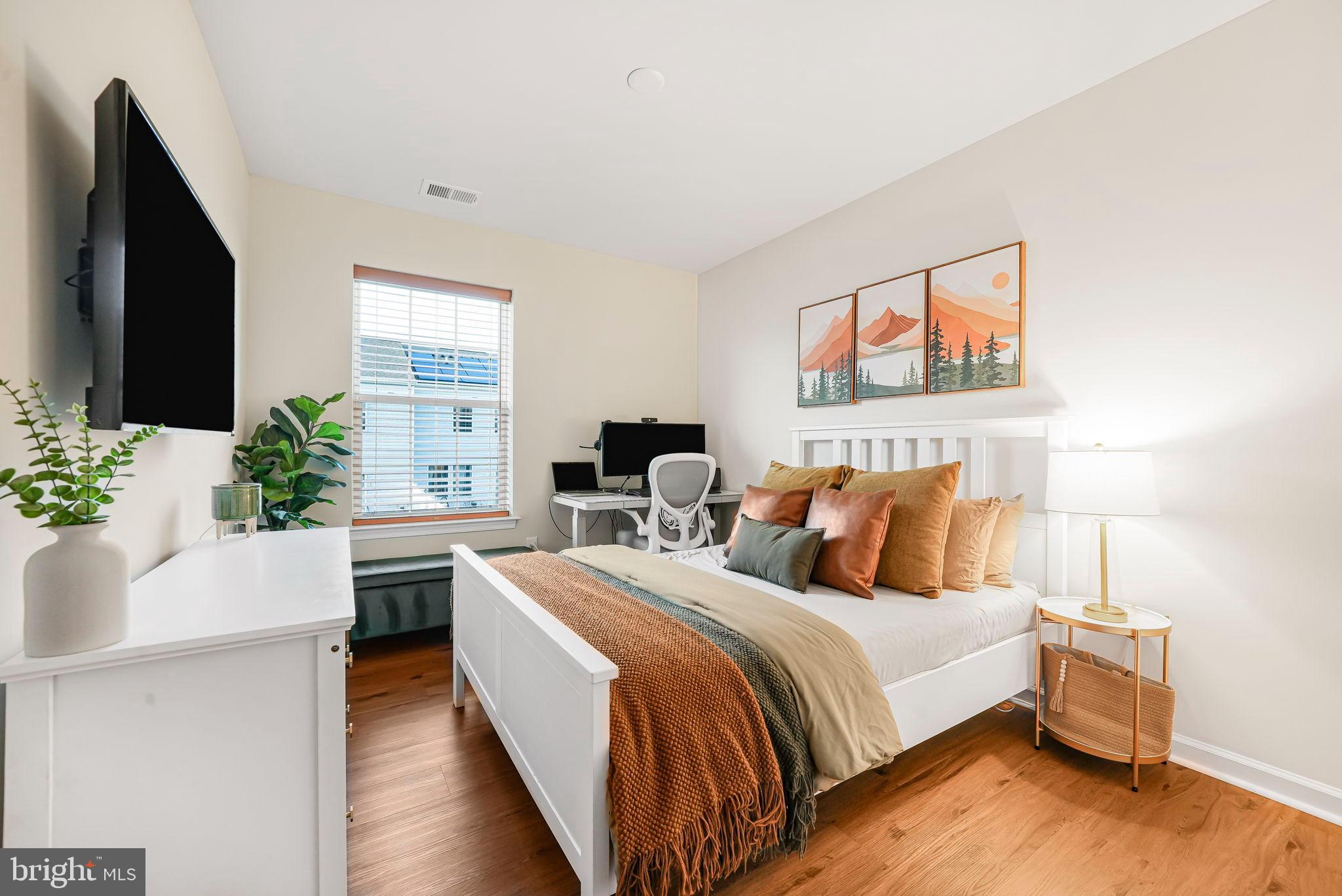 69 Peregrine Way Burlington, NJ 08016 - Photo 22 of 28 a bed room with bed and a potted plant