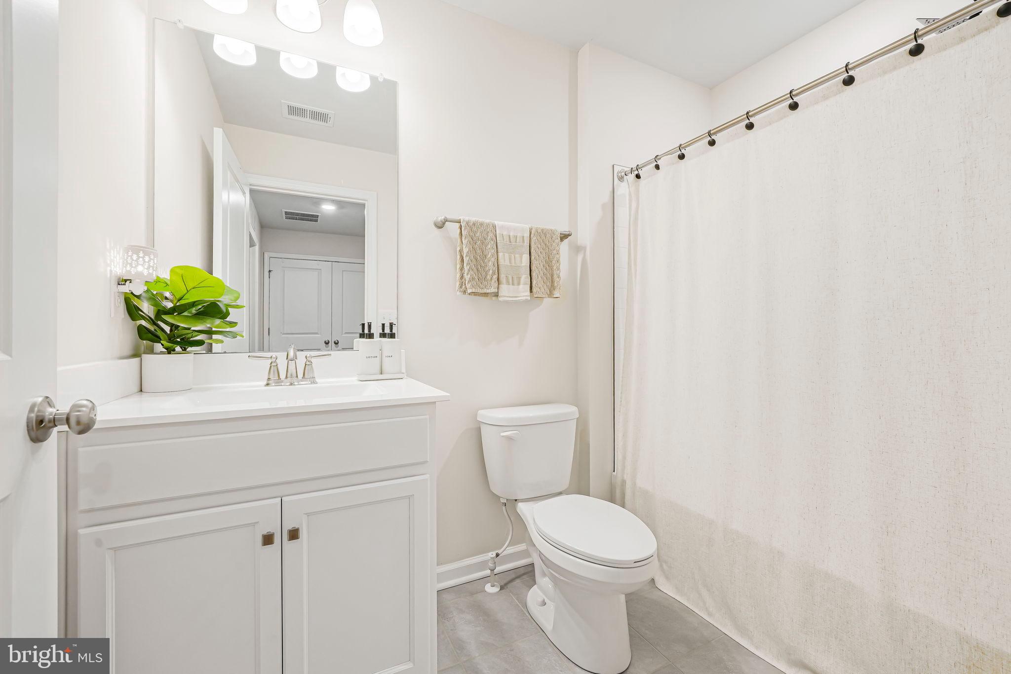 69 Peregrine Way Burlington, NJ 08016 - Photo 24 of 28 a bathroom with a sink a toilet and shower