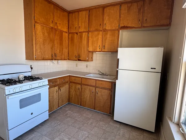 an empty room with closet and a chandelier fan