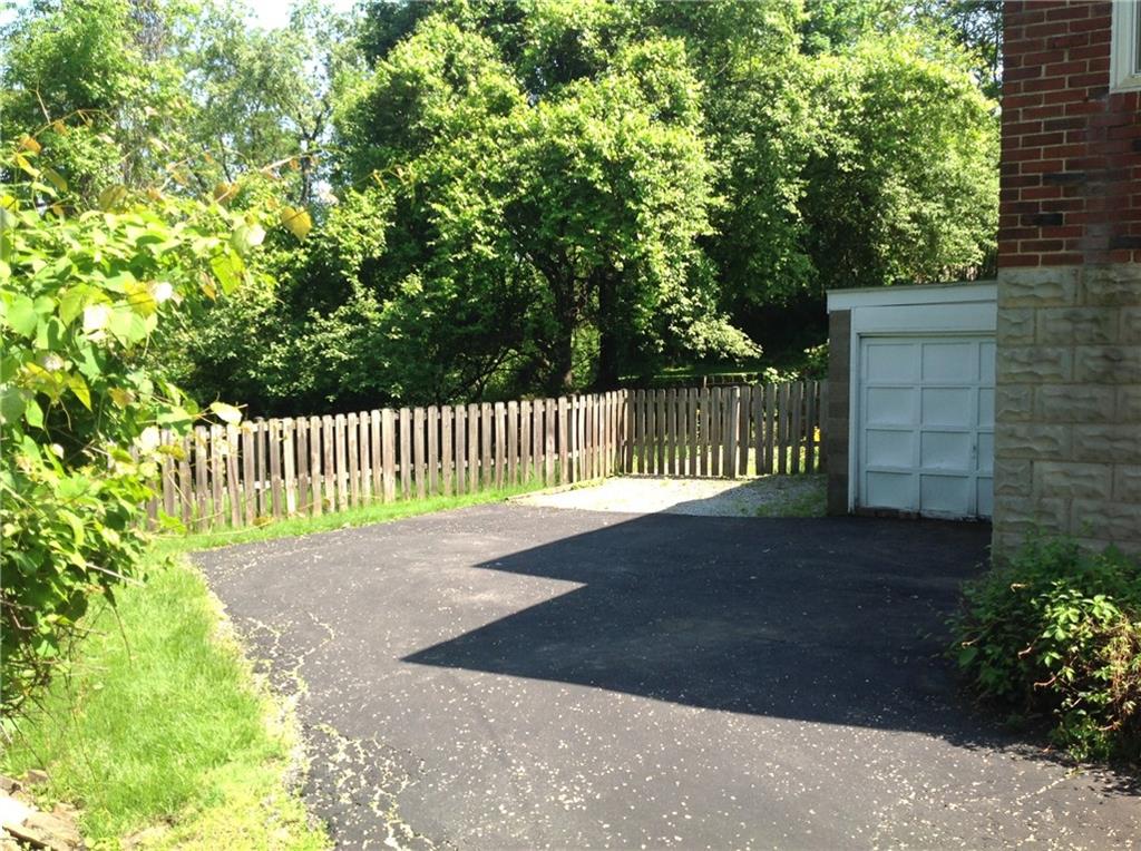 928 Braddock Road Pittsburgh, PA 15221 - Photo 21 of 24 Driveway with fence and easy to maintain yard.