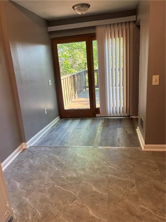 335 Cedarhurst Street Pittsburgh, PA 15210 - Photo 7 of 28 an empty room with wooden floor and windows
