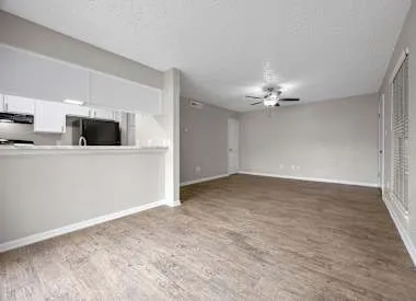 a kitchen with granite countertop a refrigerator and a sink
