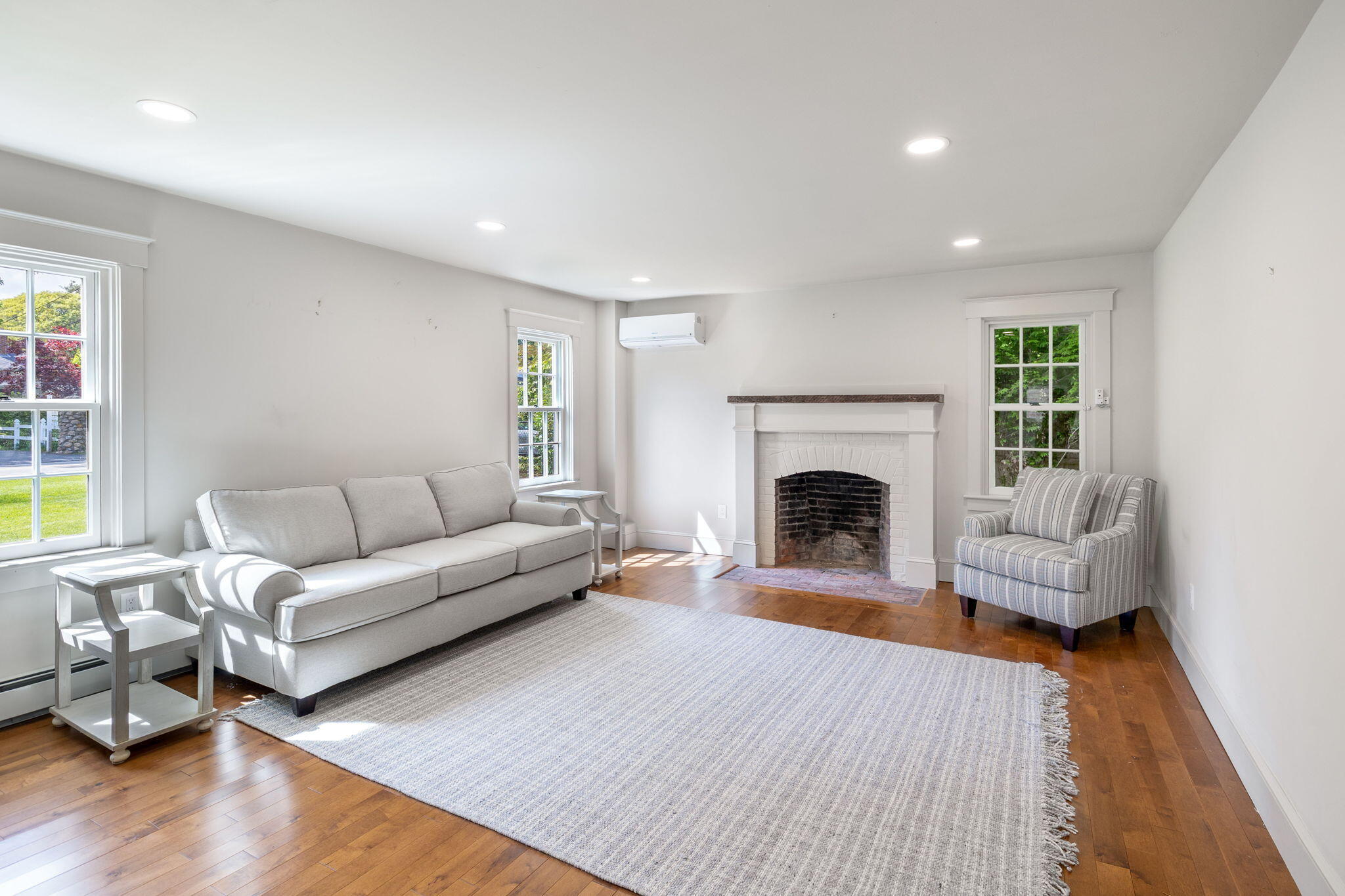 1180 Main Street Cotuit, MA 02635 - Photo 15 of 82 a living room with furniture and a fireplace