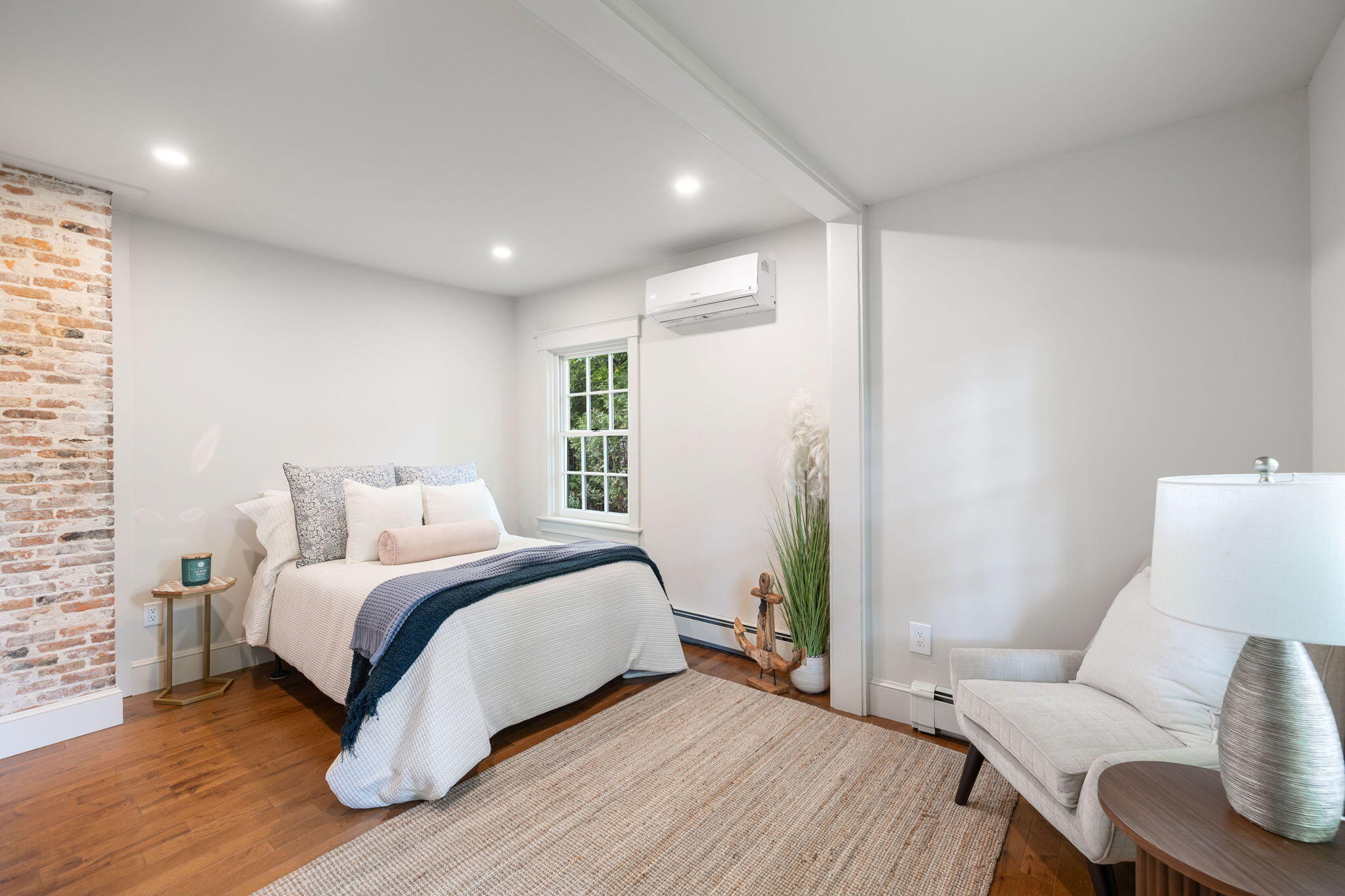 1180 Main Street Cotuit, MA 02635 - Photo 19 of 82 a bedroom with a bed and a couch