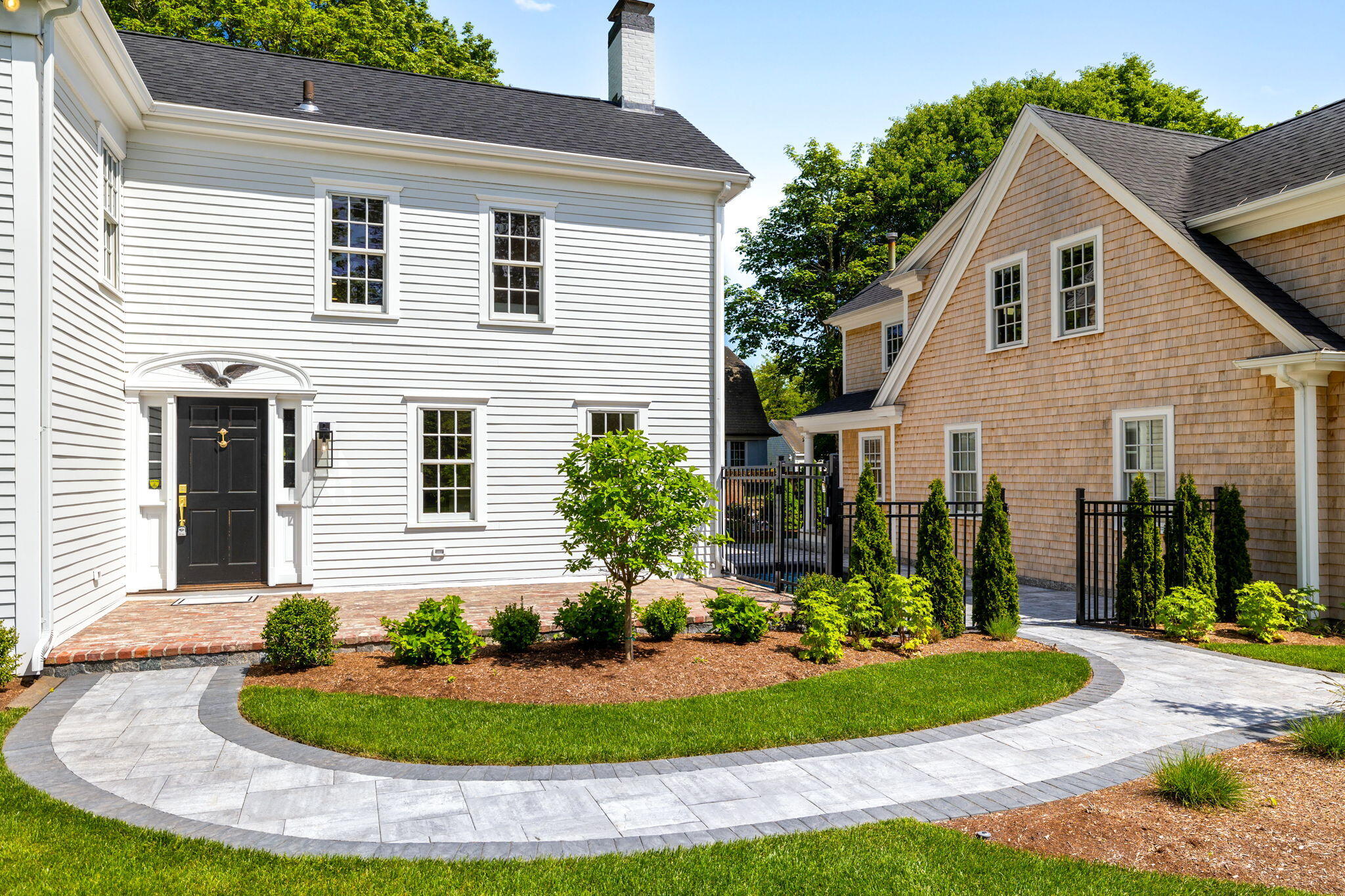 1180 Main Street Cotuit, MA 02635 - Photo 60 of 82 a front view of a house with a yard and garage