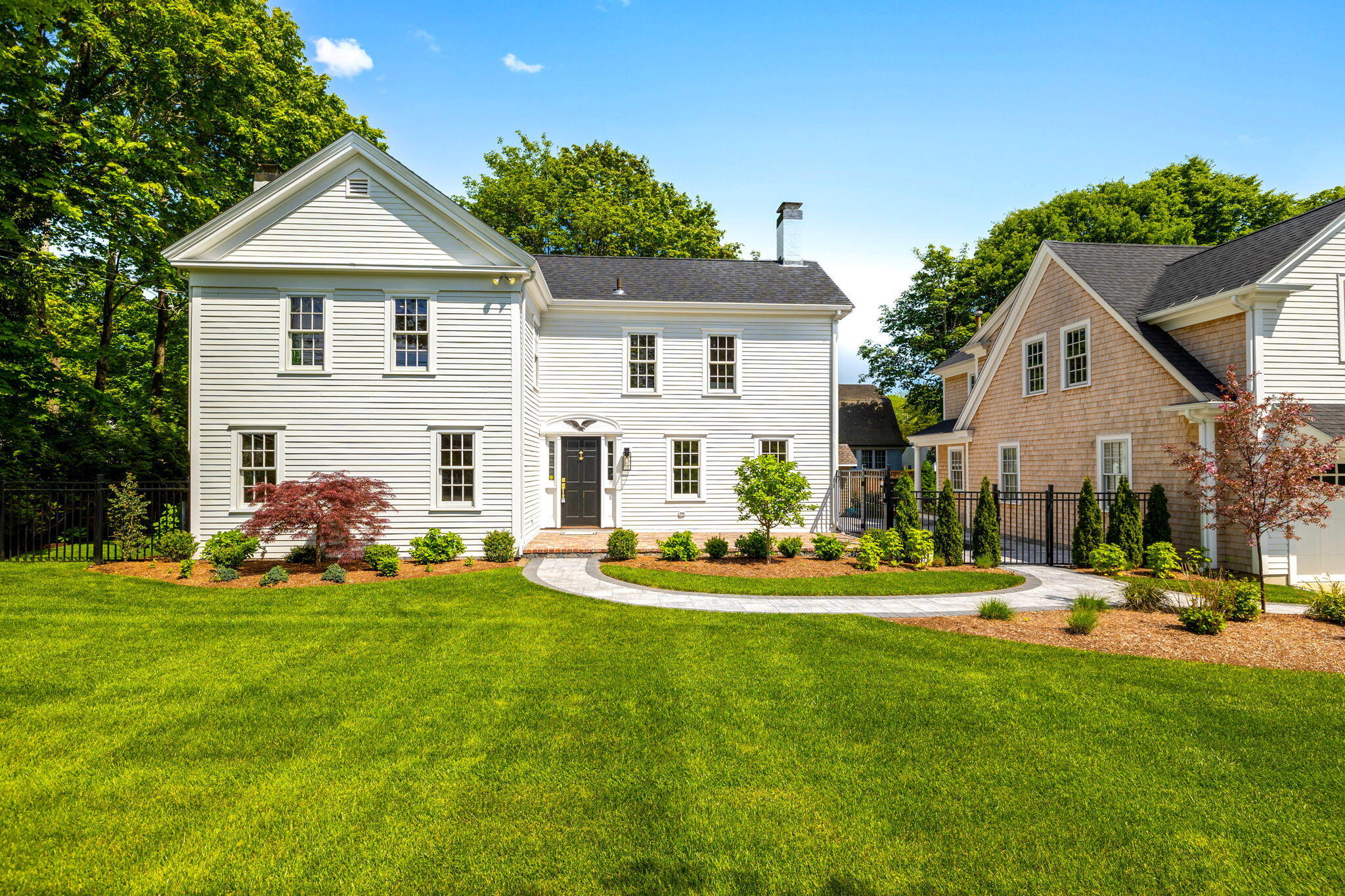 1180 Main Street Cotuit, MA 02635 - Photo 64 of 82 a front view of a house with a yard table and chairs