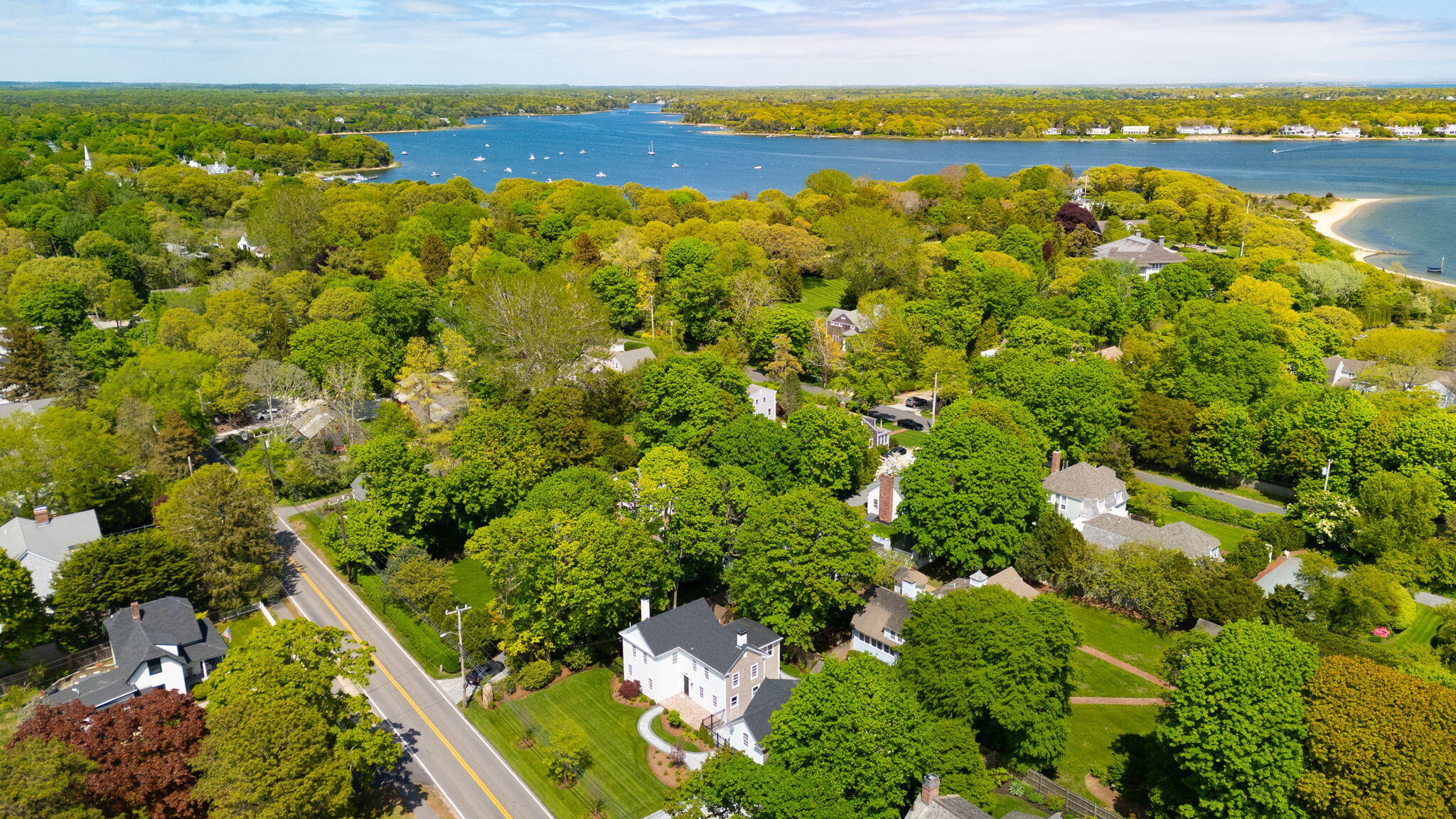 1180 Main Street Cotuit, MA 02635 - Photo 72 of 82 a view of a lake with a building in the background