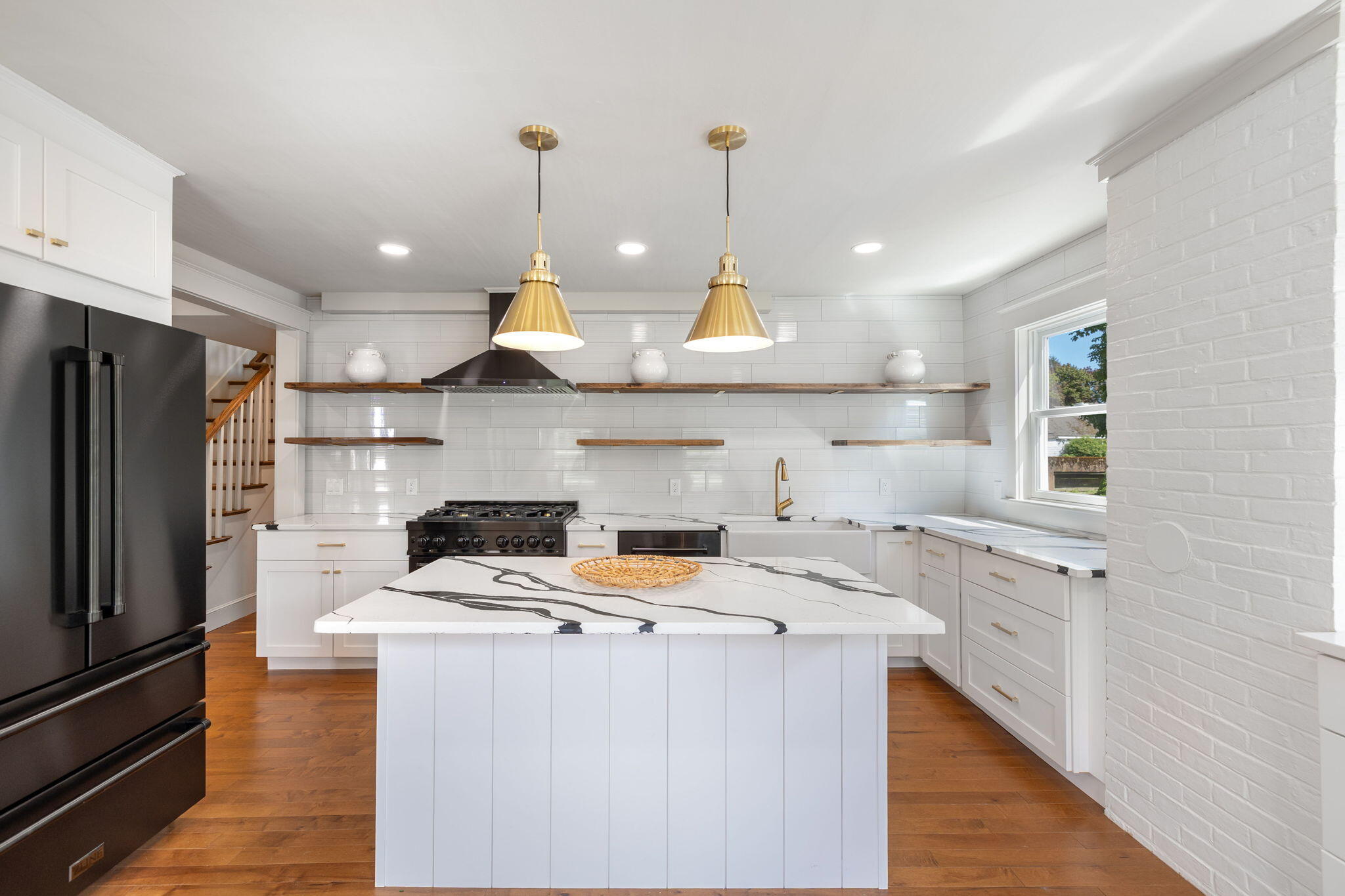 1180 Main Street Cotuit, MA 02635 - Photo 10 of 82 a kitchen with stainless steel appliances granite countertop a stove a sink a refrigerator and white cabinets with wooden floor