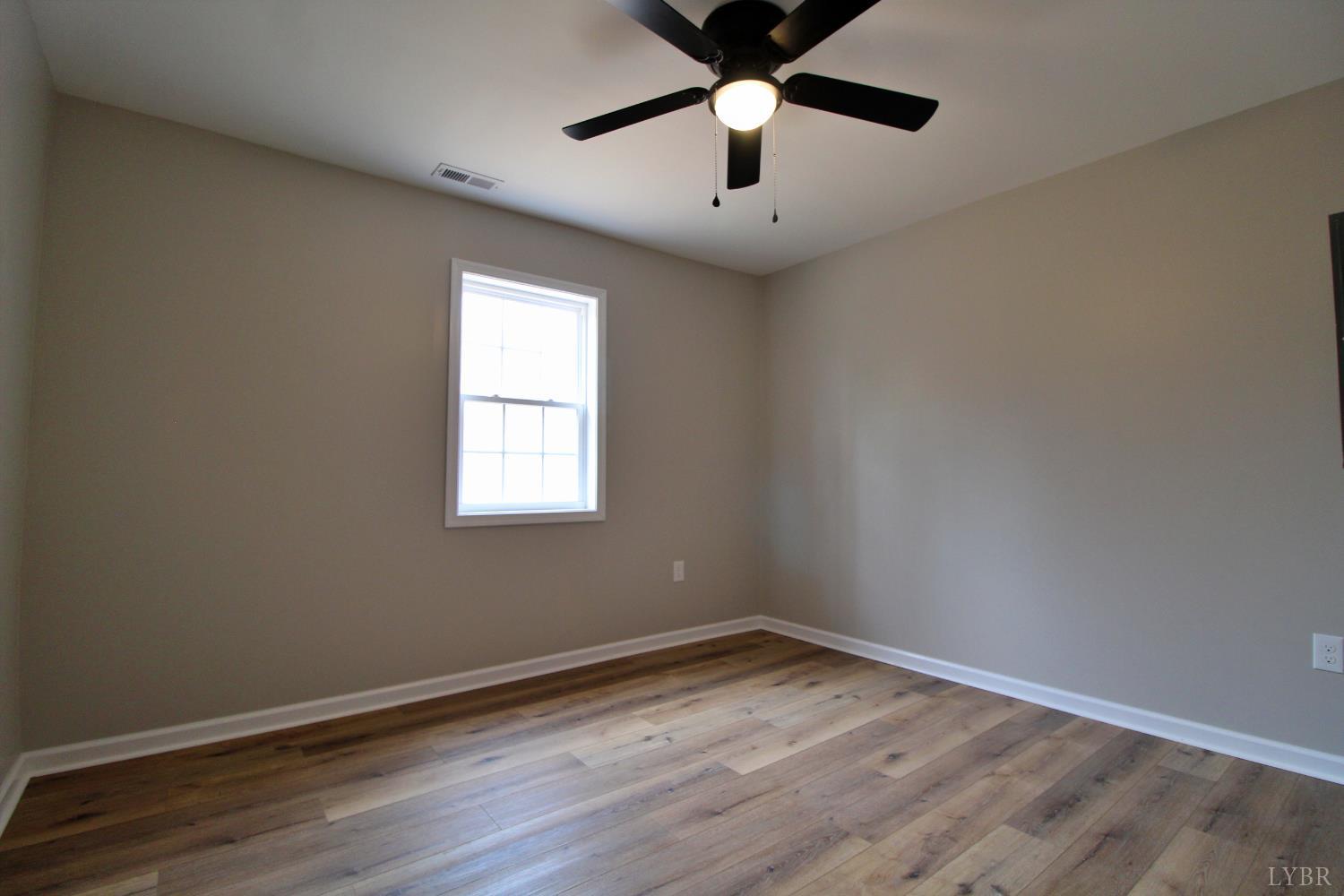 1740 Watt Abbitt Road Appomattox, VA 24522 - Photo 15 of 29 an empty room with a window and a ceiling fan