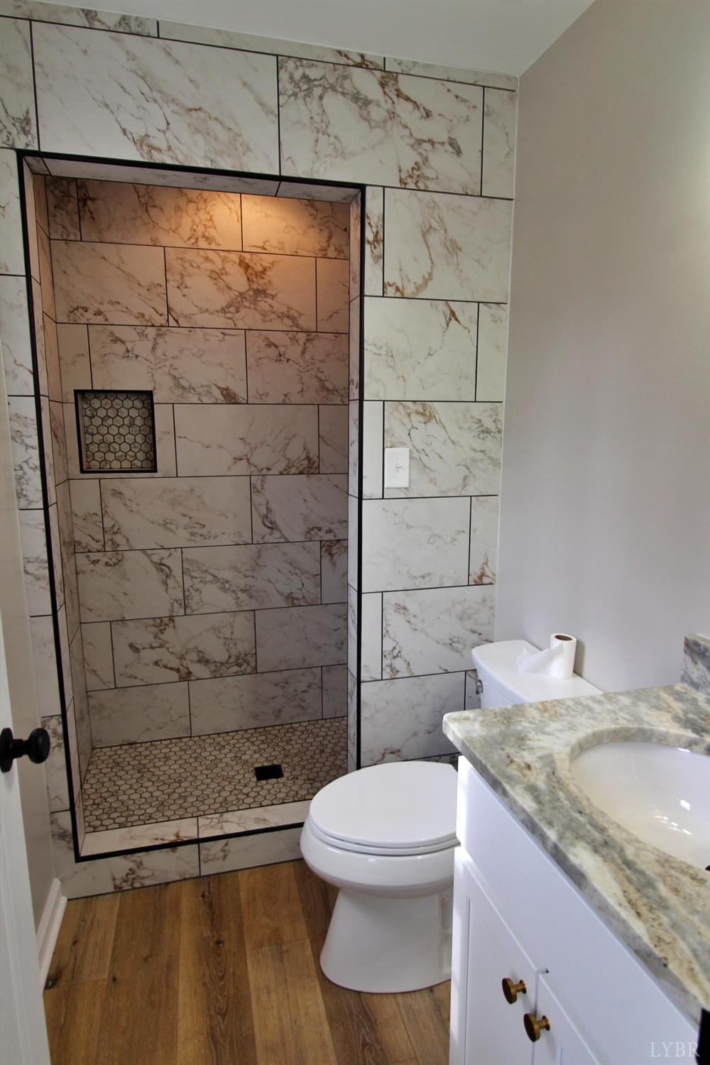1740 Watt Abbitt Road Appomattox, VA 24522 - Photo 17 of 29 a bathroom with a granite countertop sink toilet and shower
