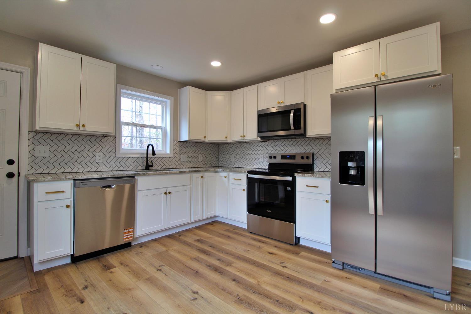 1740 Watt Abbitt Road Appomattox, VA 24522 - Photo 18 of 29 a kitchen with stainless steel appliances granite countertop a refrigerator sink and microwave