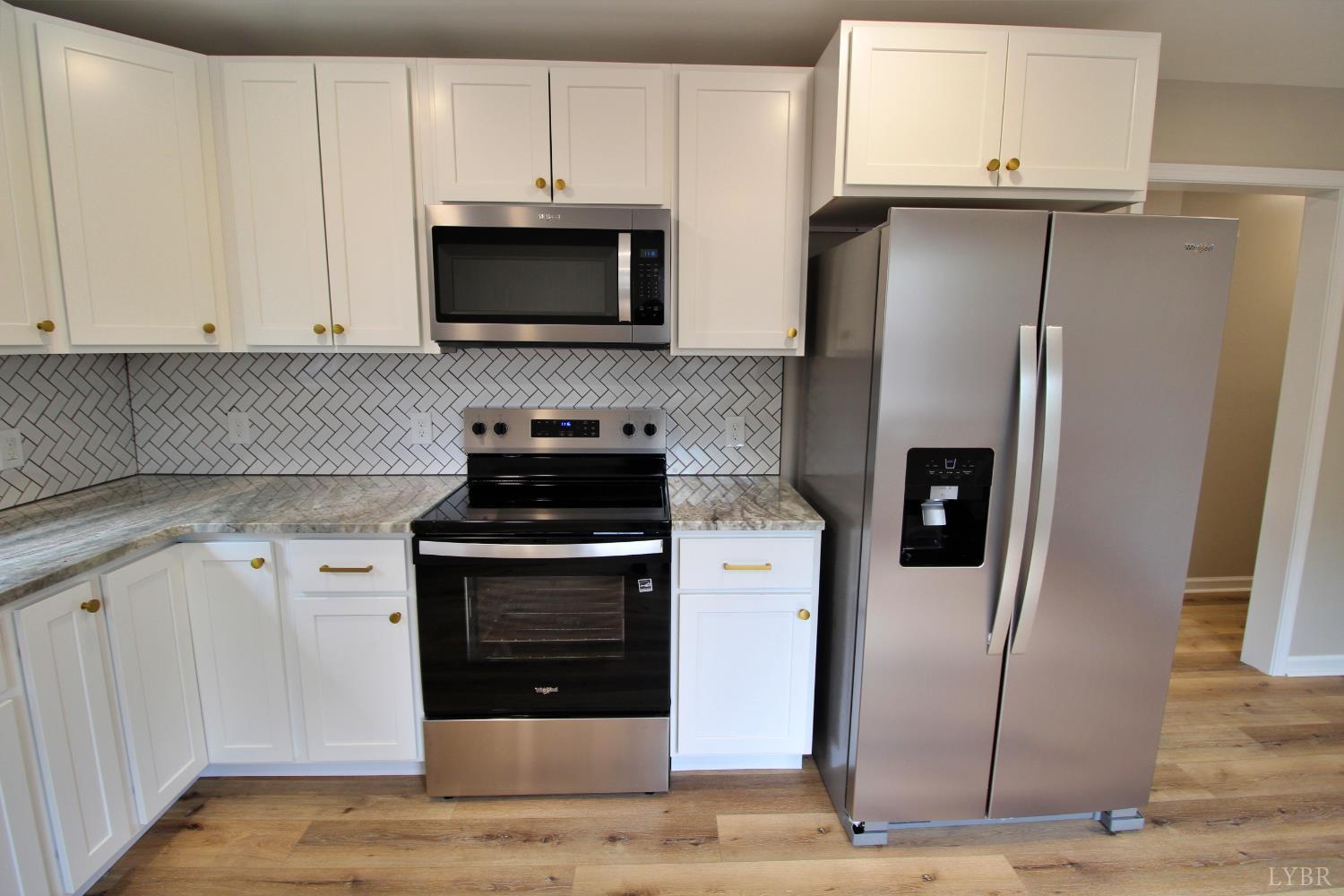 1740 Watt Abbitt Road Appomattox, VA 24522 - Photo 21 of 29 a kitchen with cabinets stainless steel appliances and a counter space