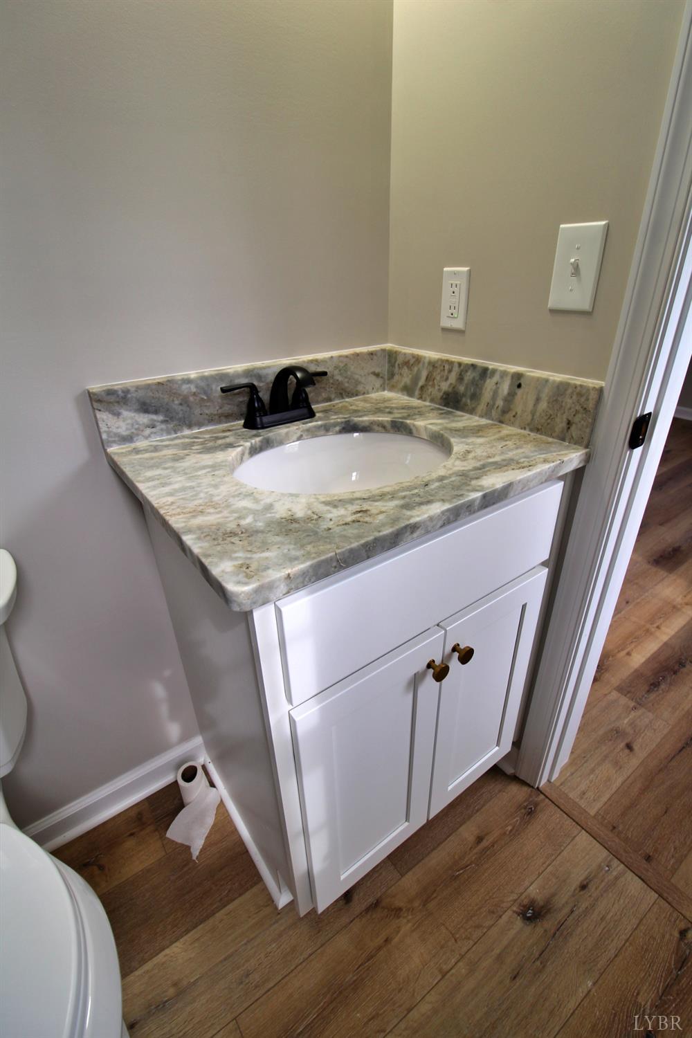 1740 Watt Abbitt Road Appomattox, VA 24522 - Photo 23 of 29 a bathroom with a granite countertop sink and a mirror