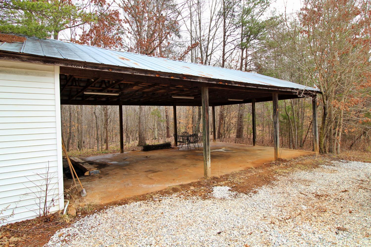 1740 Watt Abbitt Road Appomattox, VA 24522 - Photo 28 of 29 a backyard of a house with barbeque oven table and chairs