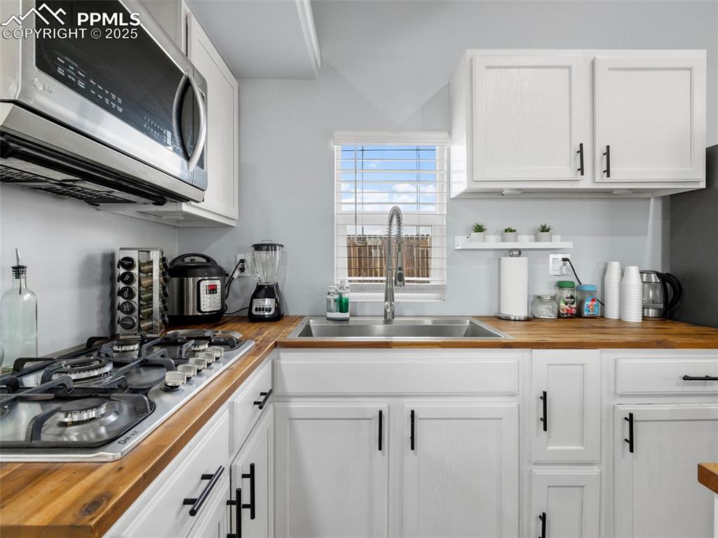 32092 Torrence Road Yoder, CO 80864 - Photo 11 of 44 a kitchen with stainless steel appliances granite countertop a sink stove and cabinets
