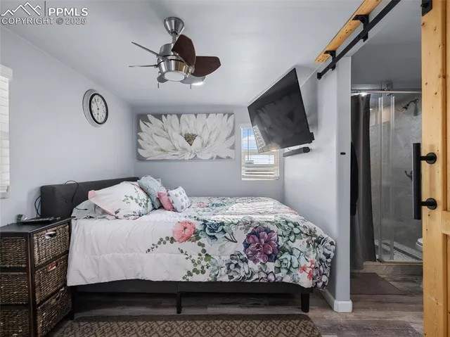 a bedroom with a bed and a flat screen tv