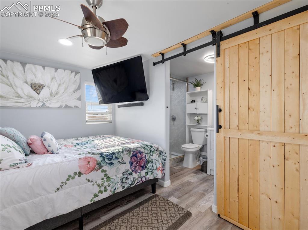 32092 Torrence Road Yoder, CO 80864 - Photo 15 of 44 a bedroom with a bed and a flat screen tv