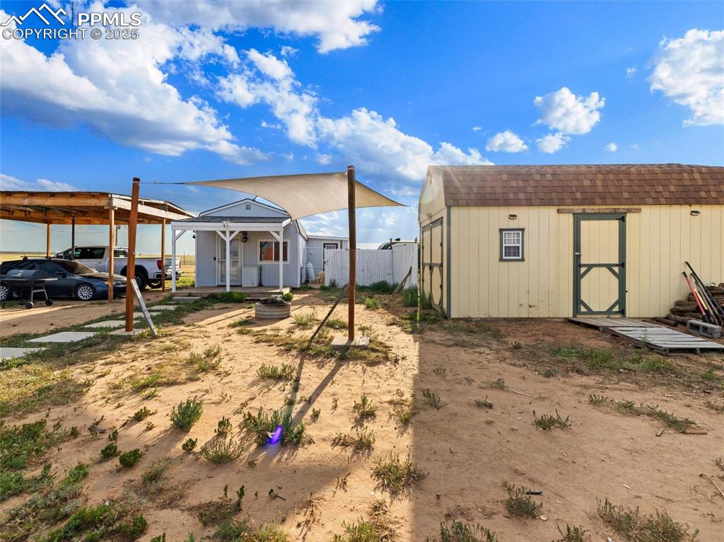 32092 Torrence Road Yoder, CO 80864 - Photo 38 of 44 a view of a white house with a yard