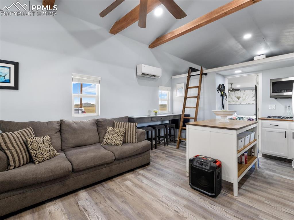 32092 Torrence Road Yoder, CO 80864 - Photo 8 of 44 a living room with furniture and a wooden floor