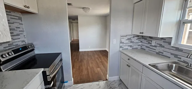 a kitchen that has a sink and a stove