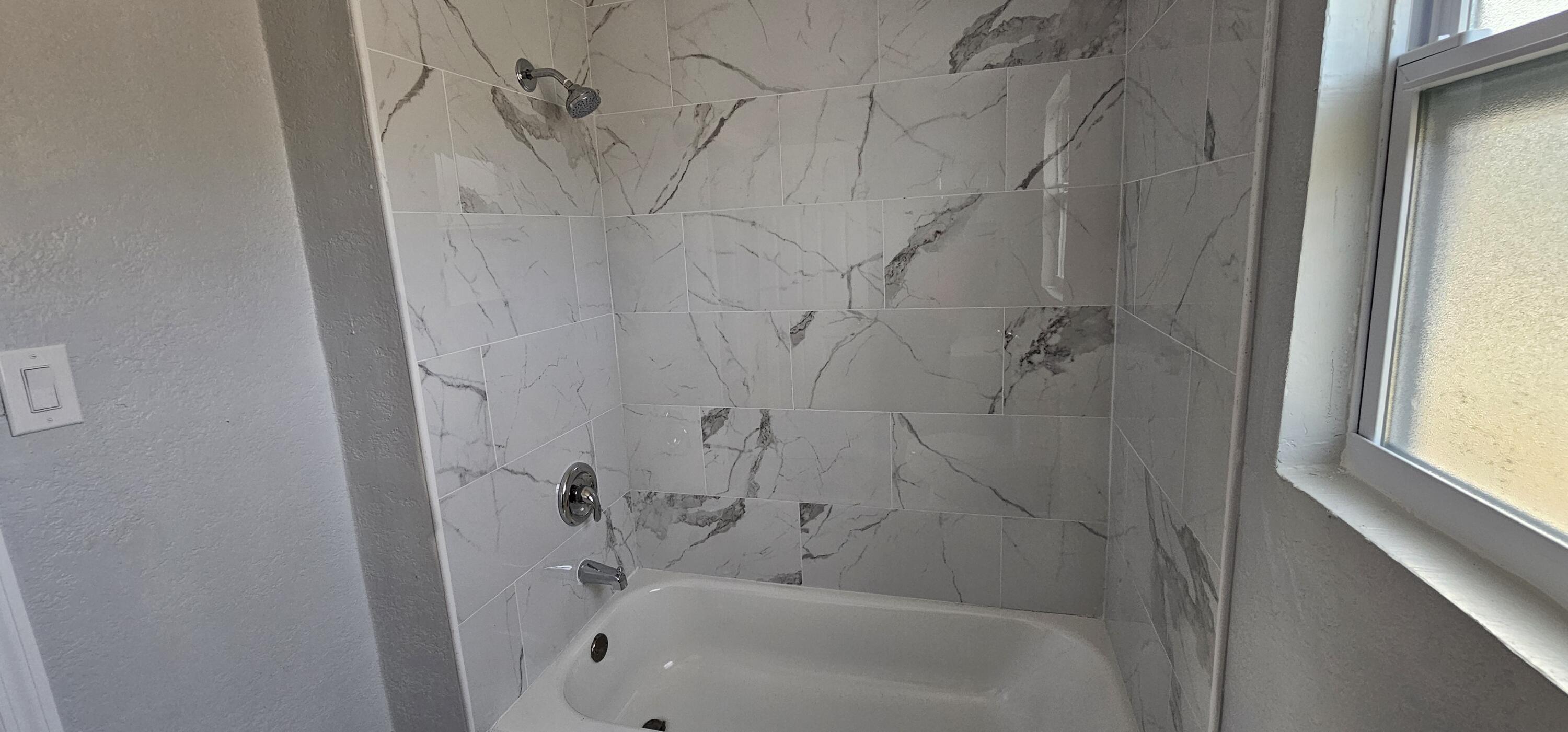 540 Southwest 9th Street Belle Glade, FL 33430 - Photo 14 of 28 a bathroom with a bathtub