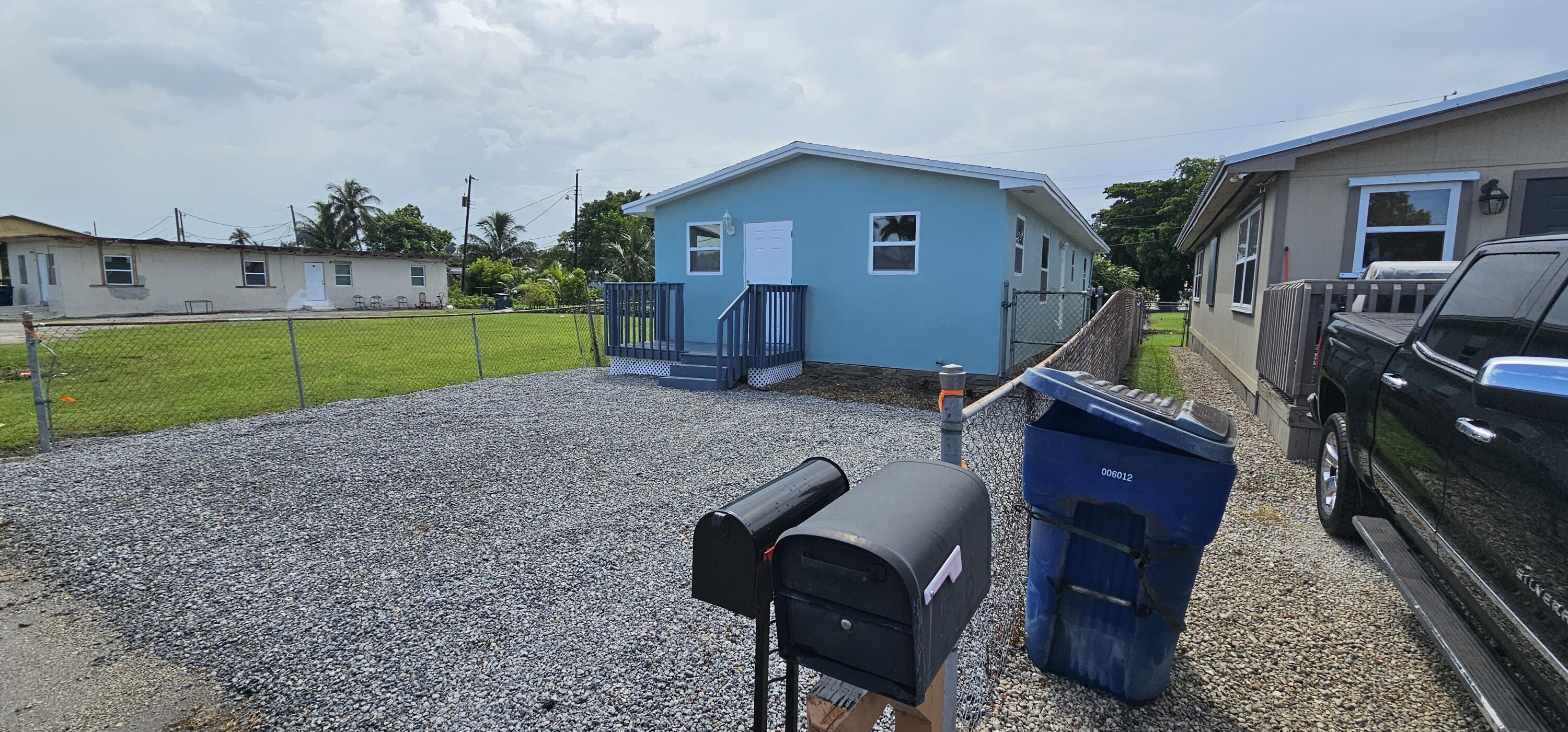 540 Southwest 9th Street Belle Glade, FL 33430 - Photo 2 of 28 a view of backyard with trampoline