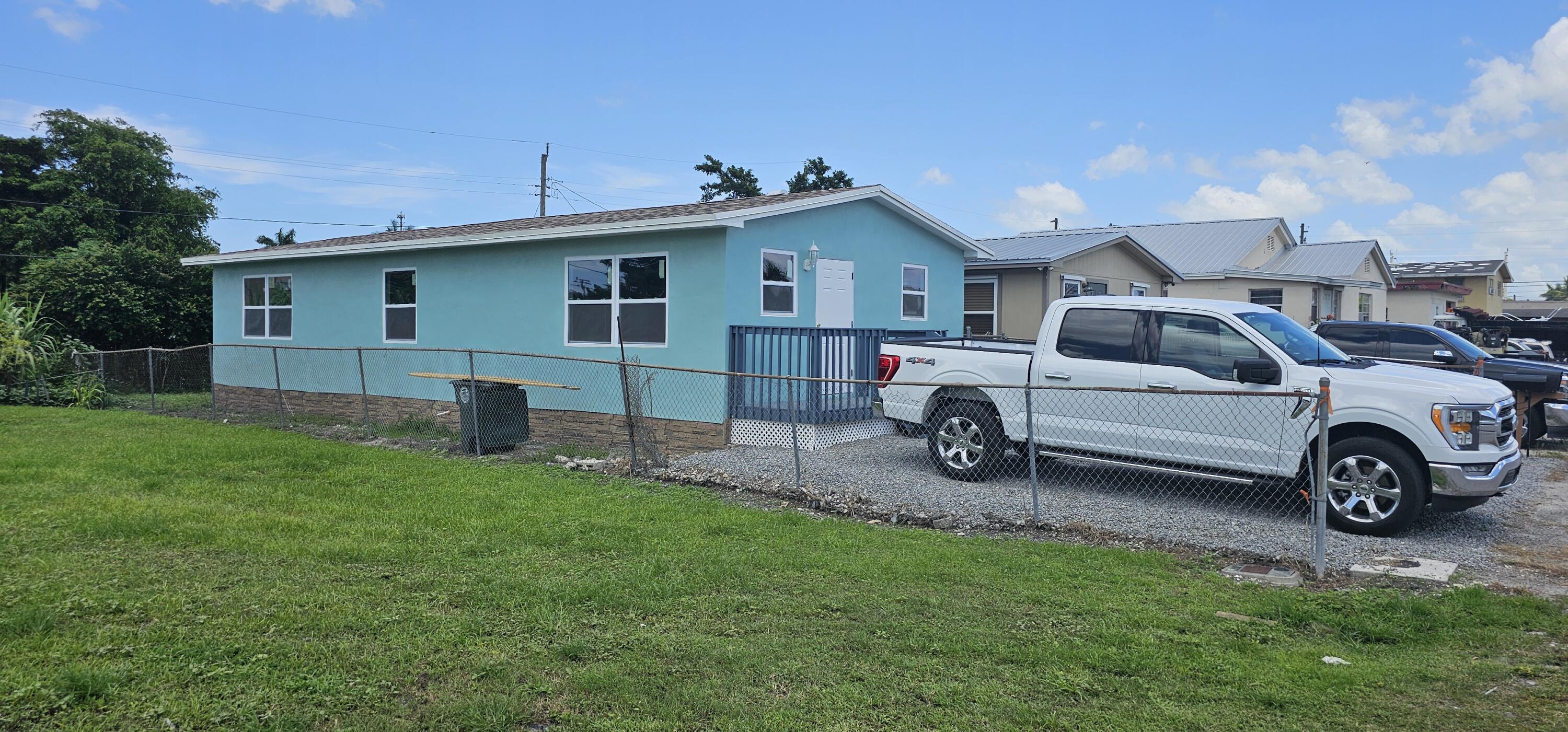 540 Southwest 9th Street Belle Glade, FL 33430 - Photo 26 of 28 a view of a house with a back yard