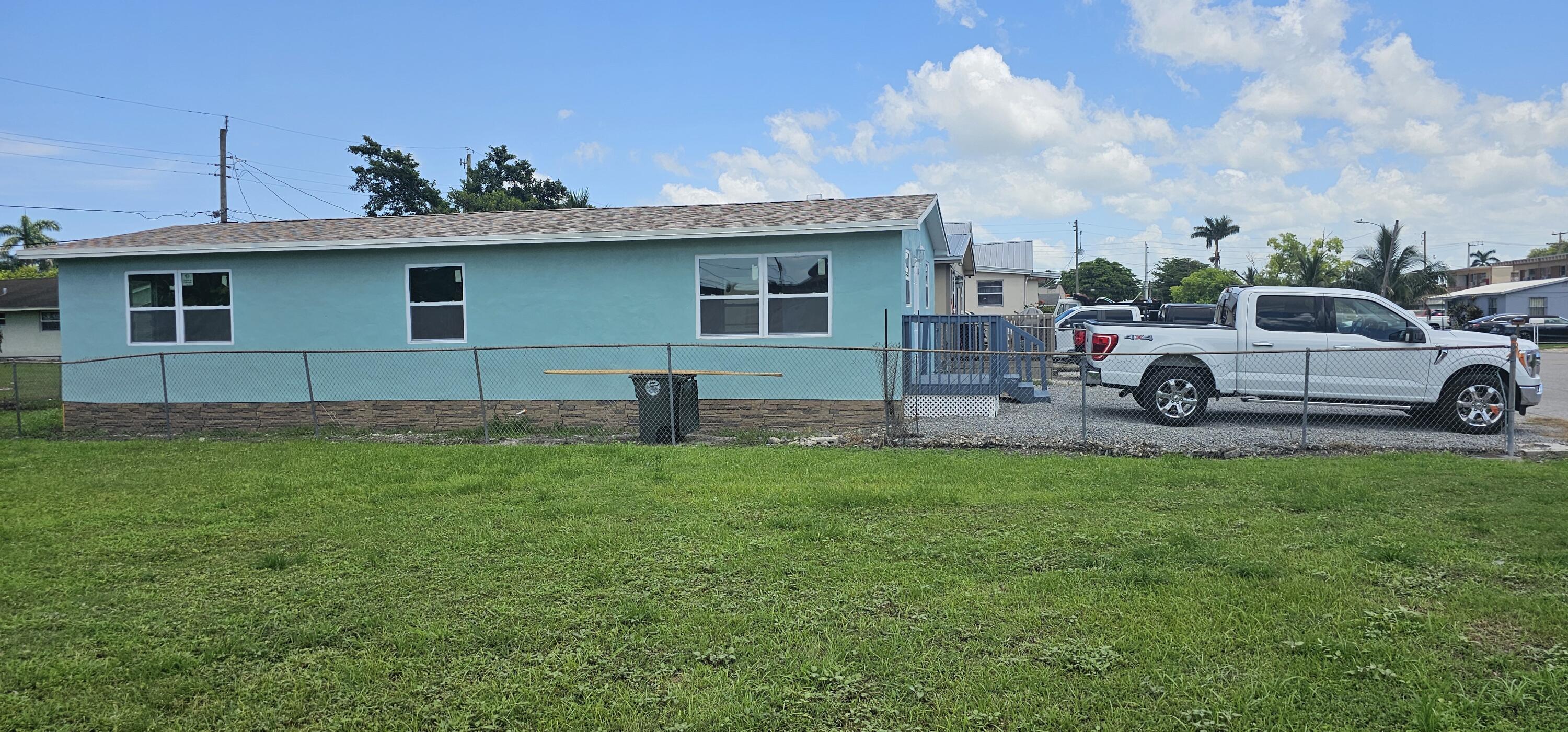 540 Southwest 9th Street Belle Glade, FL 33430 - Photo 27 of 28 a house view with a garden space
