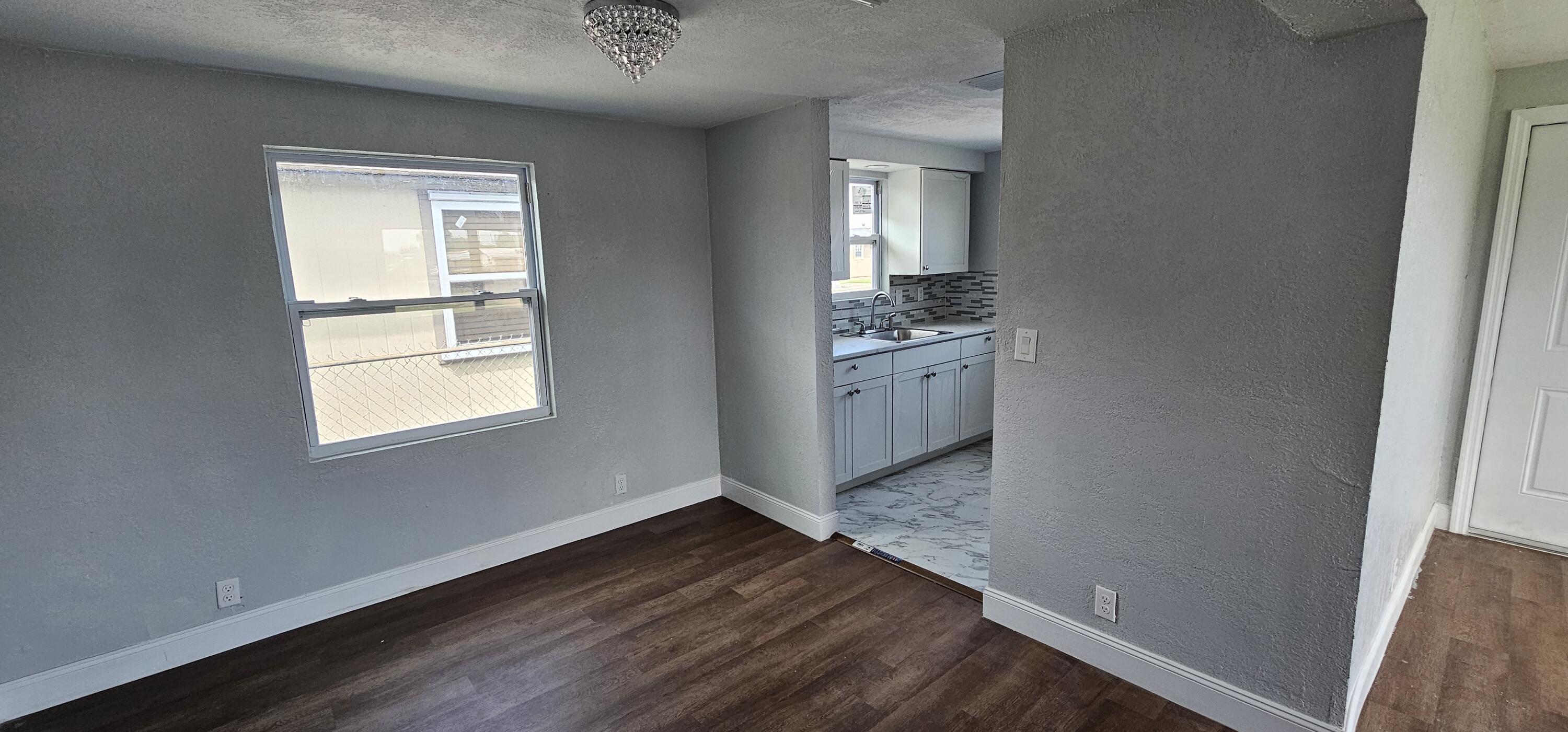 540 Southwest 9th Street Belle Glade, FL 33430 - Photo 6 of 28 an empty room with windows