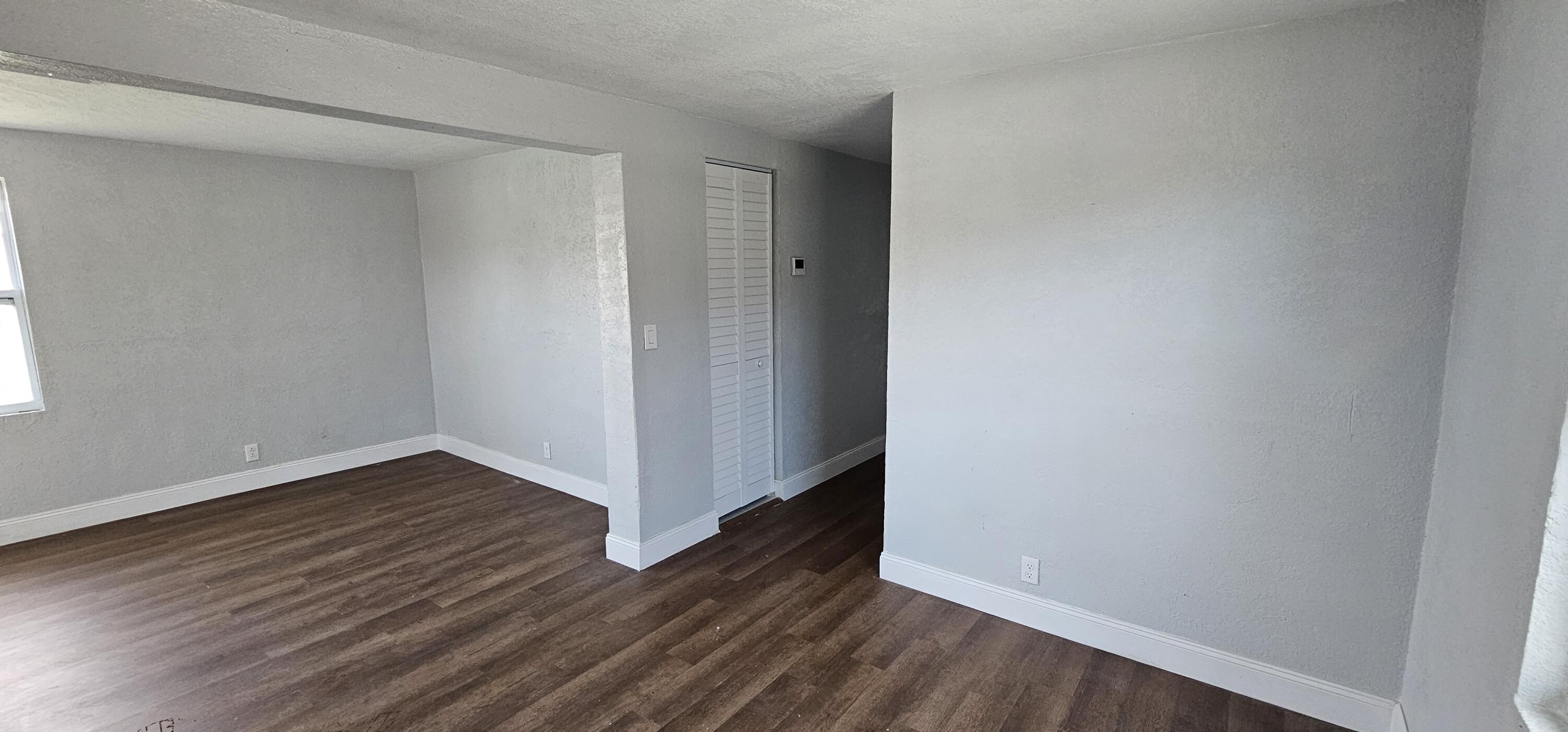 540 Southwest 9th Street Belle Glade, FL 33430 - Photo 7 of 28 a view of an empty room with wooden floor