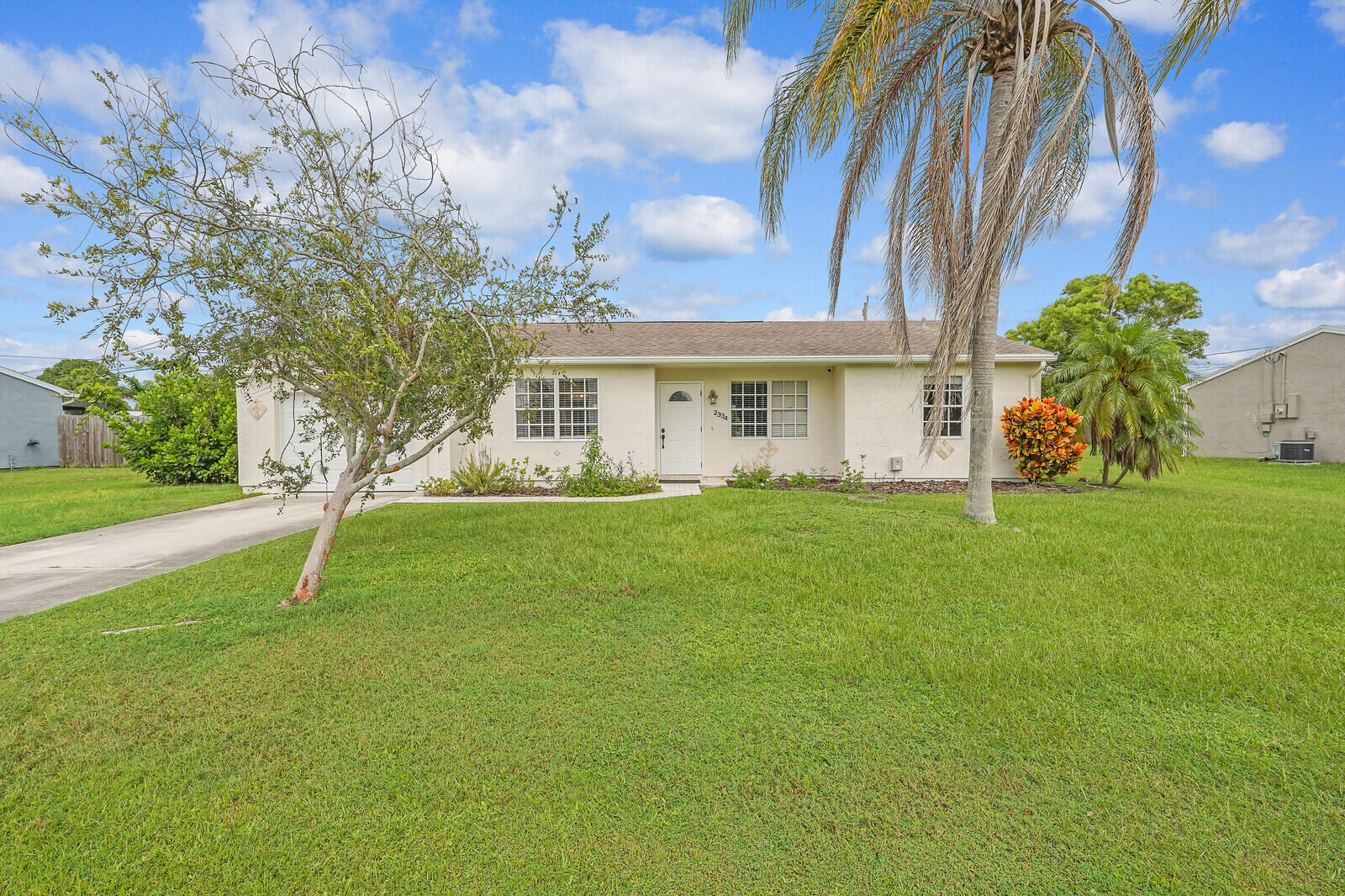2334 Southeast Merrill Road Port St. Lucie, FL 34952 - Photo 1 of 27 a house view with garden space