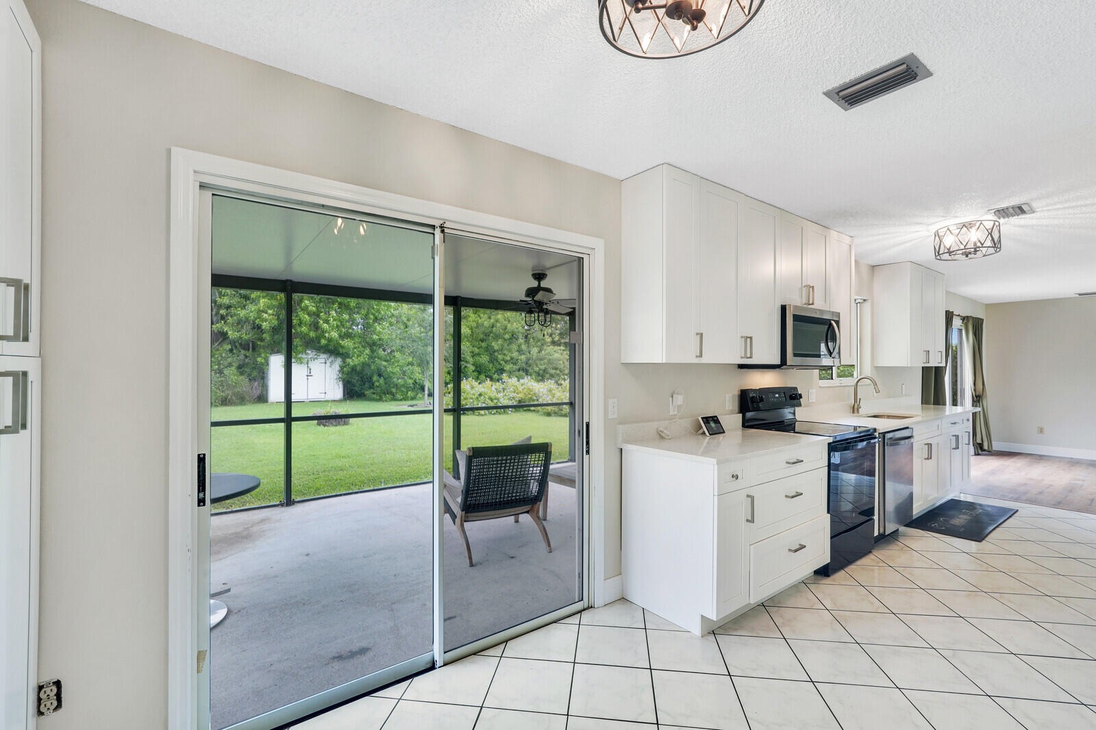 2334 Southeast Merrill Road Port St. Lucie, FL 34952 - Photo 11 of 27 a kitchen with a stove a sink and a refrigerator