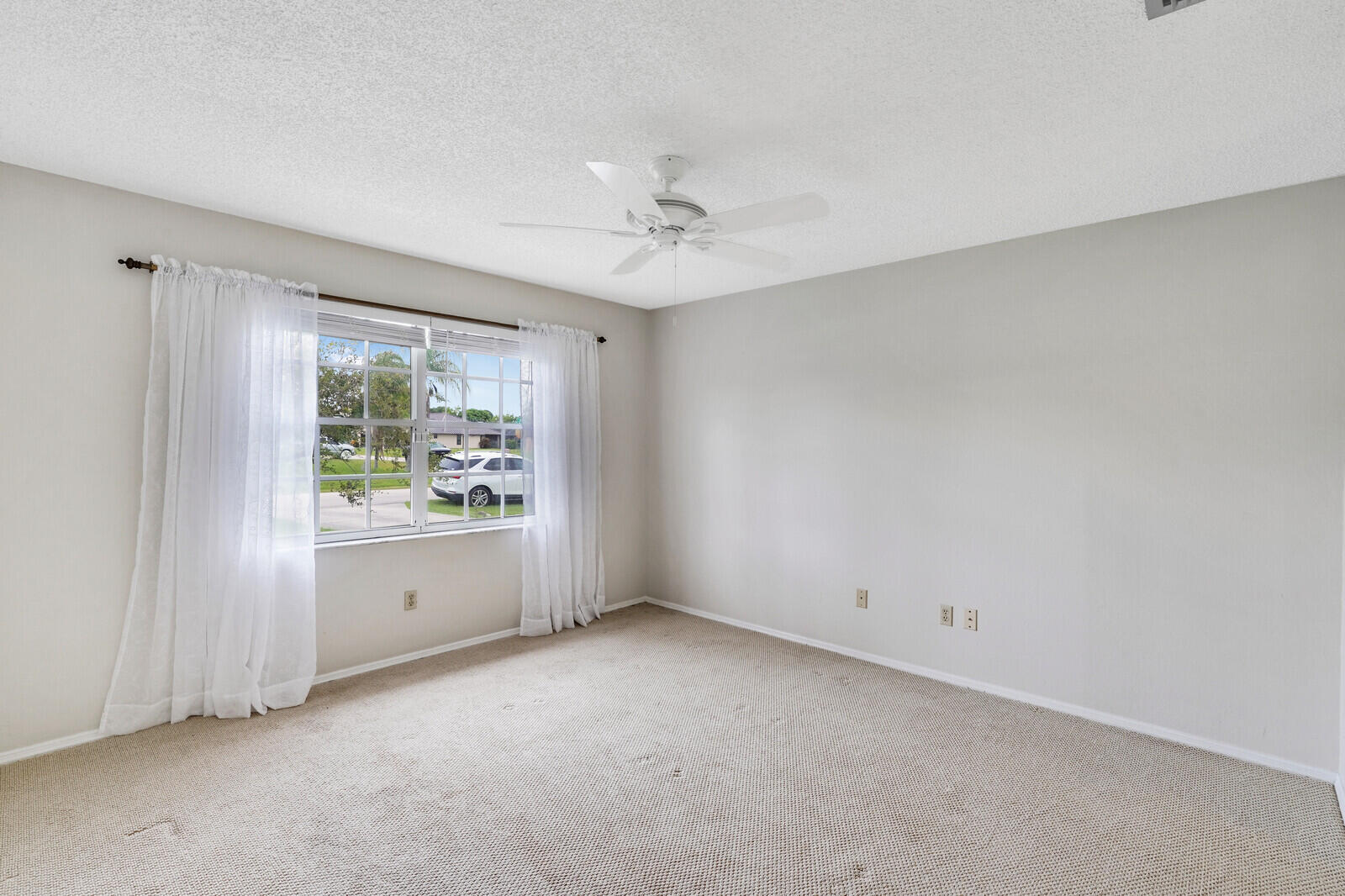 2334 Southeast Merrill Road Port St. Lucie, FL 34952 - Photo 13 of 27 an empty room with windows and ceiling fan