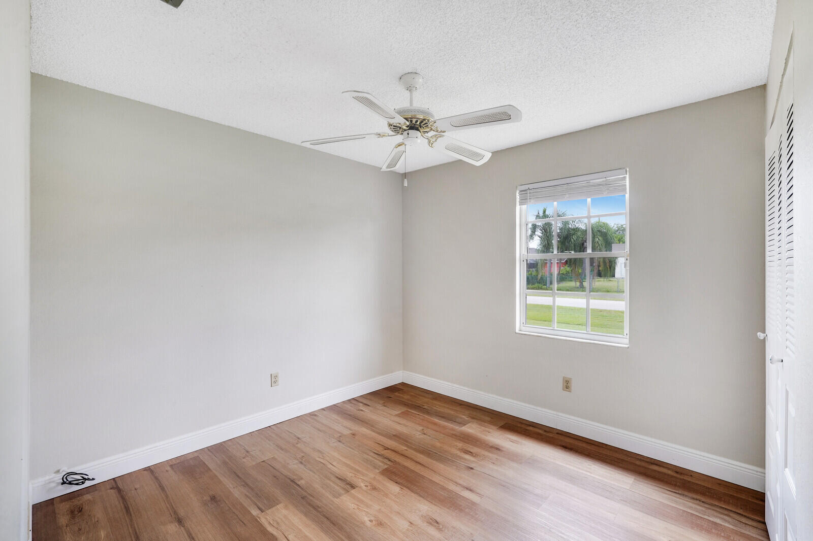 2334 Southeast Merrill Road Port St. Lucie, FL 34952 - Photo 16 of 27 an empty room with a window and a ceiling fan