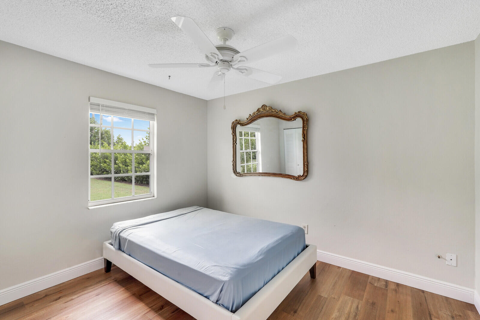2334 Southeast Merrill Road Port St. Lucie, FL 34952 - Photo 18 of 27 a bedroom with a bed and a window