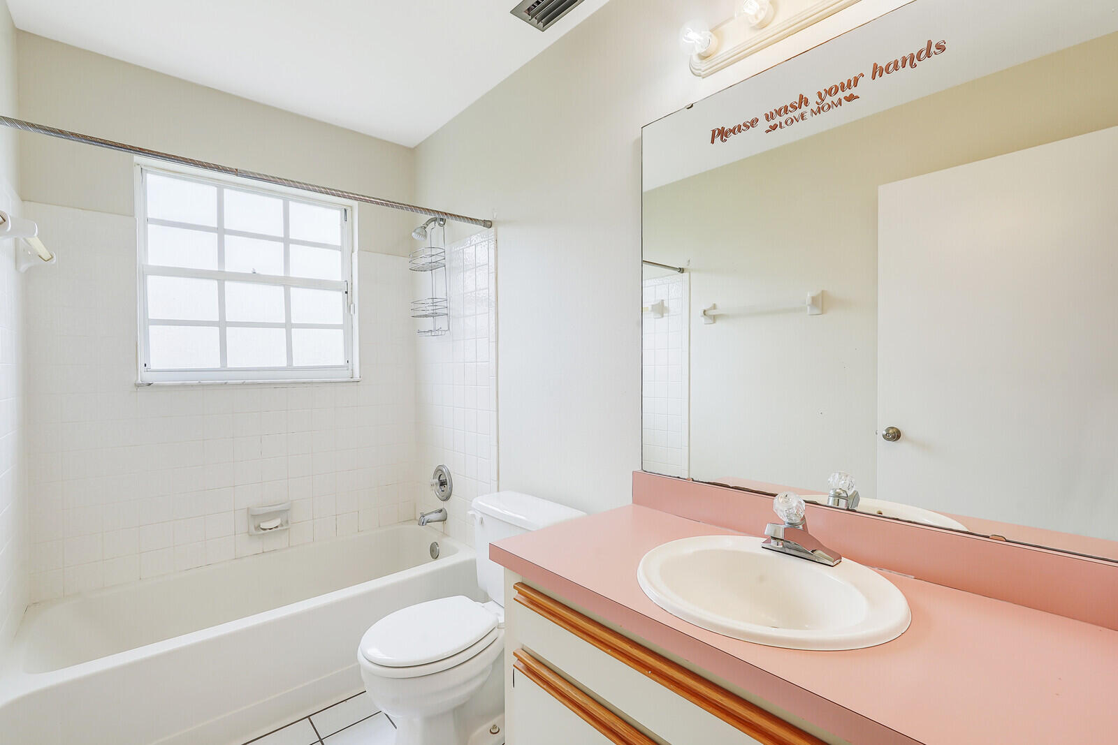 2334 Southeast Merrill Road Port St. Lucie, FL 34952 - Photo 20 of 27 a bathroom with a sink toilet a mirror and shower