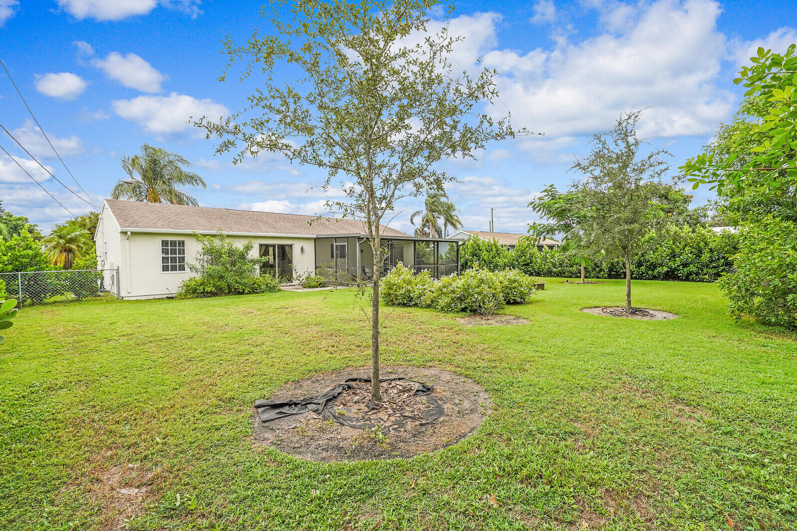 2334 Southeast Merrill Road Port St. Lucie, FL 34952 - Photo 25 of 27 a view of a house with a backyard