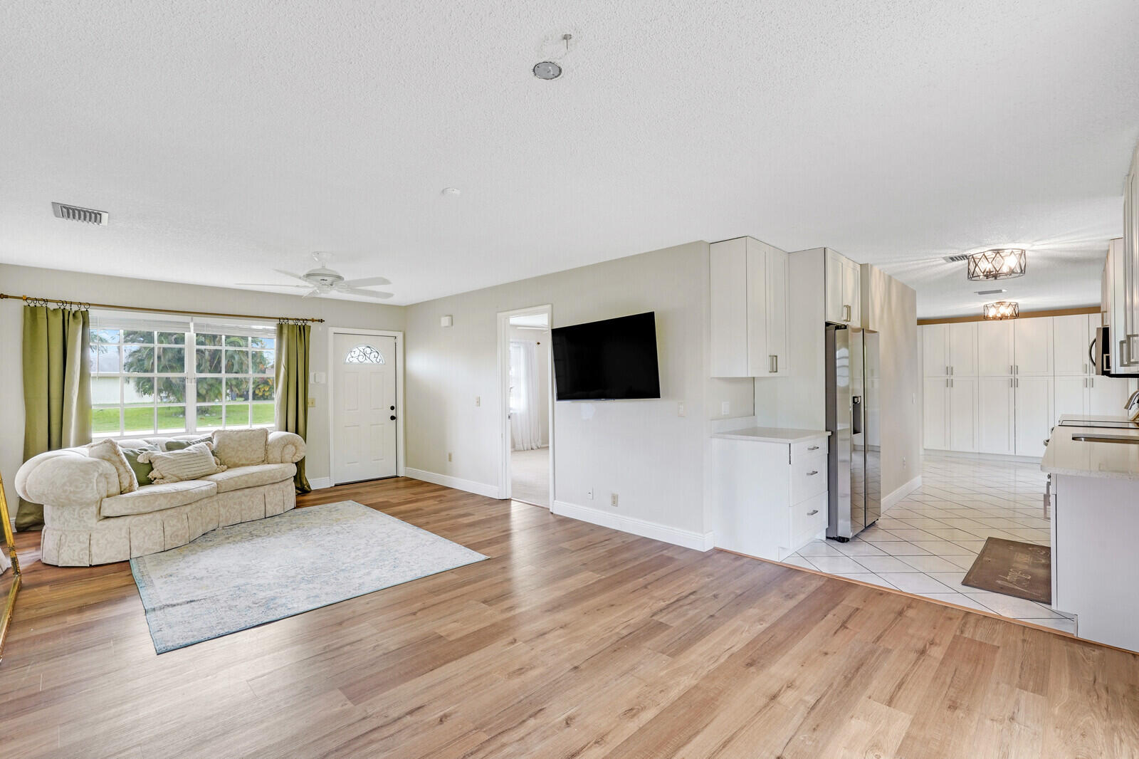 2334 Southeast Merrill Road Port St. Lucie, FL 34952 - Photo 6 of 27 a living room with furniture and a flat screen tv