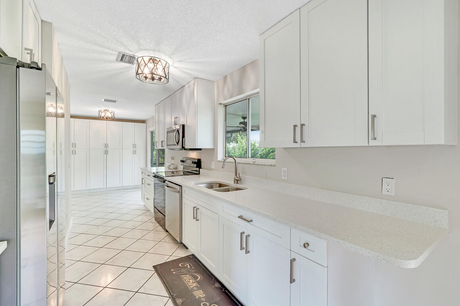 2334 Southeast Merrill Road Port St. Lucie, FL 34952 - Photo 8 of 27 a kitchen with cabinets and window