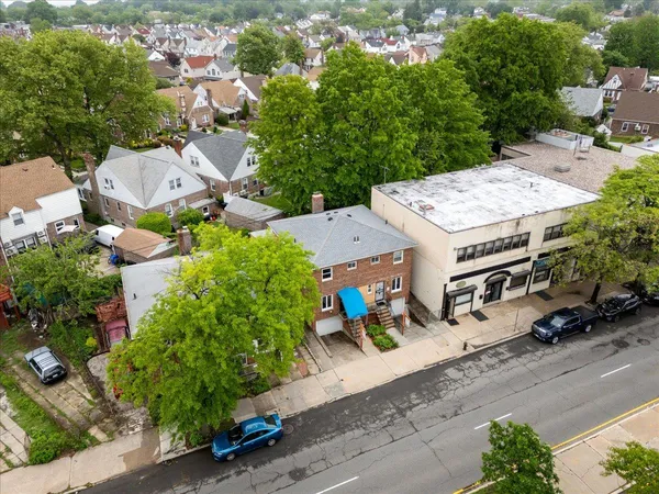 an aerial view of a house with garden space and street view