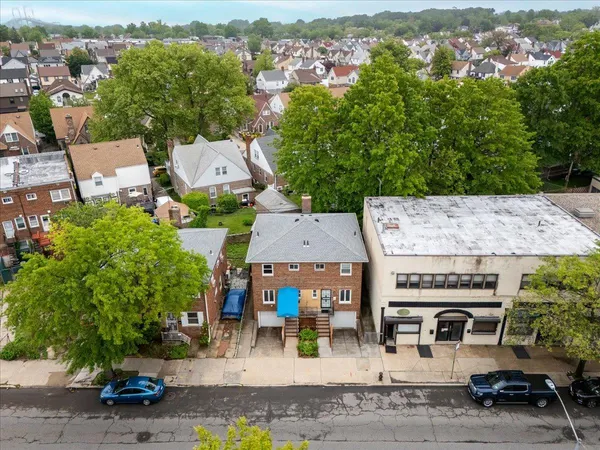 an aerial view of a house with garden space and street view