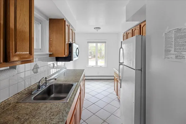 a kitchen with a sink stove and refrigerator