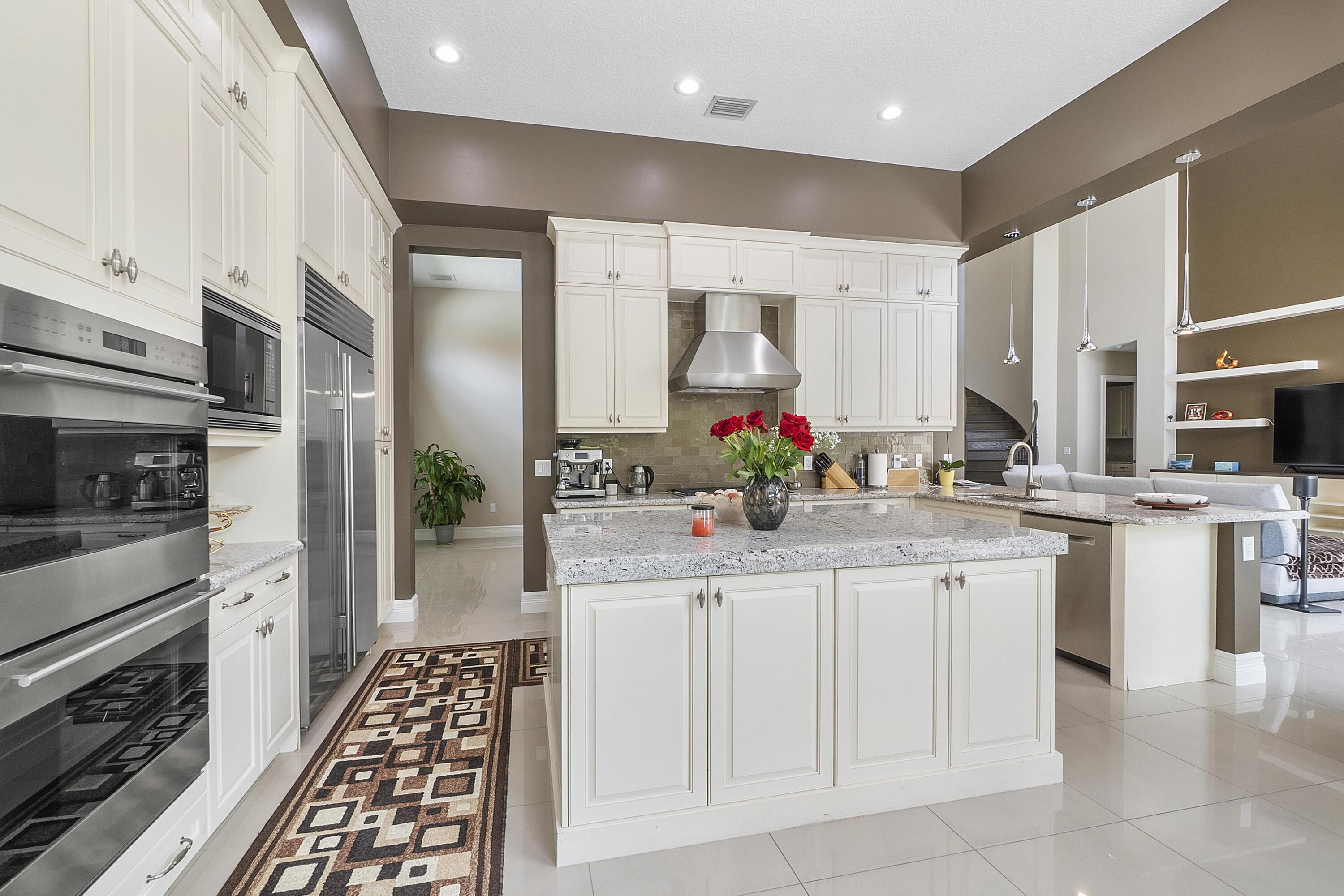 16897 Pierre Circle Delray Beach, FL 33446 - Photo 11 of 37 a kitchen with stainless steel appliances kitchen island granite countertop a sink and cabinets
