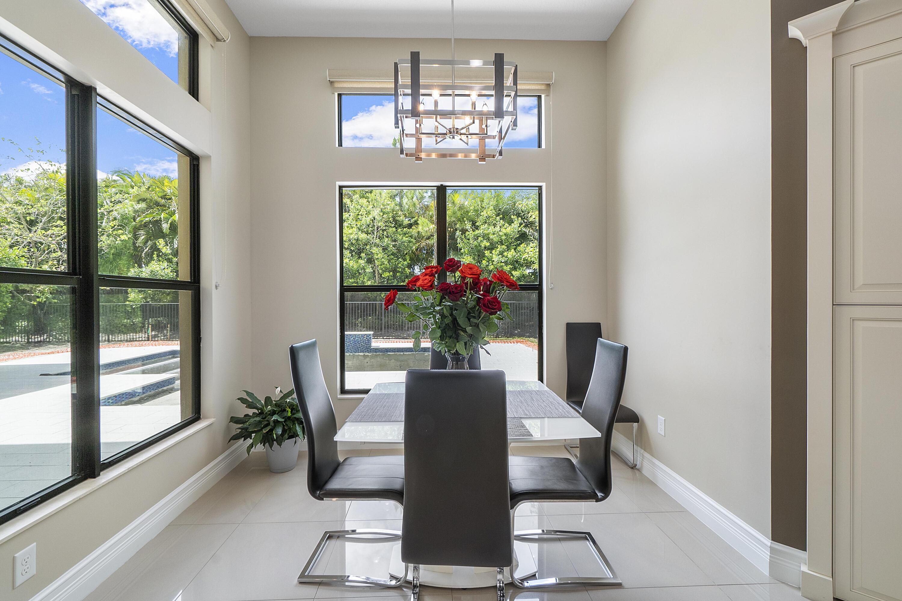 16897 Pierre Circle Delray Beach, FL 33446 - Photo 12 of 37 a view of a dining room with a window and wooden floor