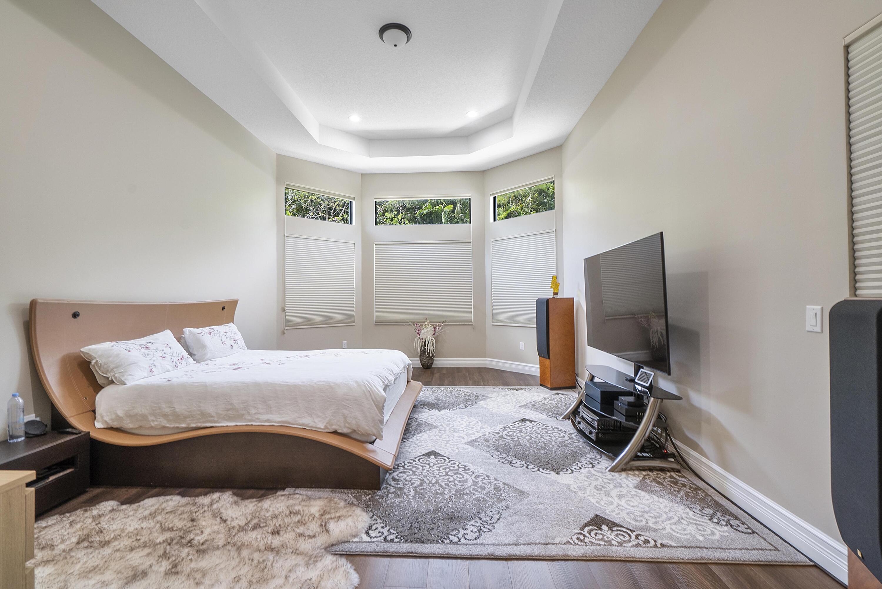 16897 Pierre Circle Delray Beach, FL 33446 - Photo 13 of 37 a bedroom with a bed and a flat screen tv