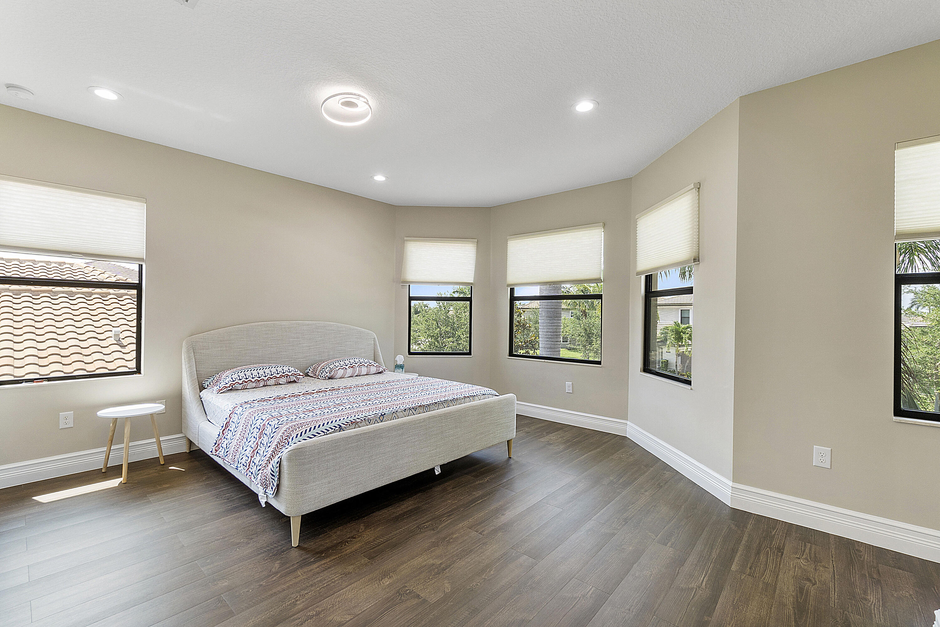 16897 Pierre Circle Delray Beach, FL 33446 - Photo 16 of 37 a bedroom with a large bed and a large window