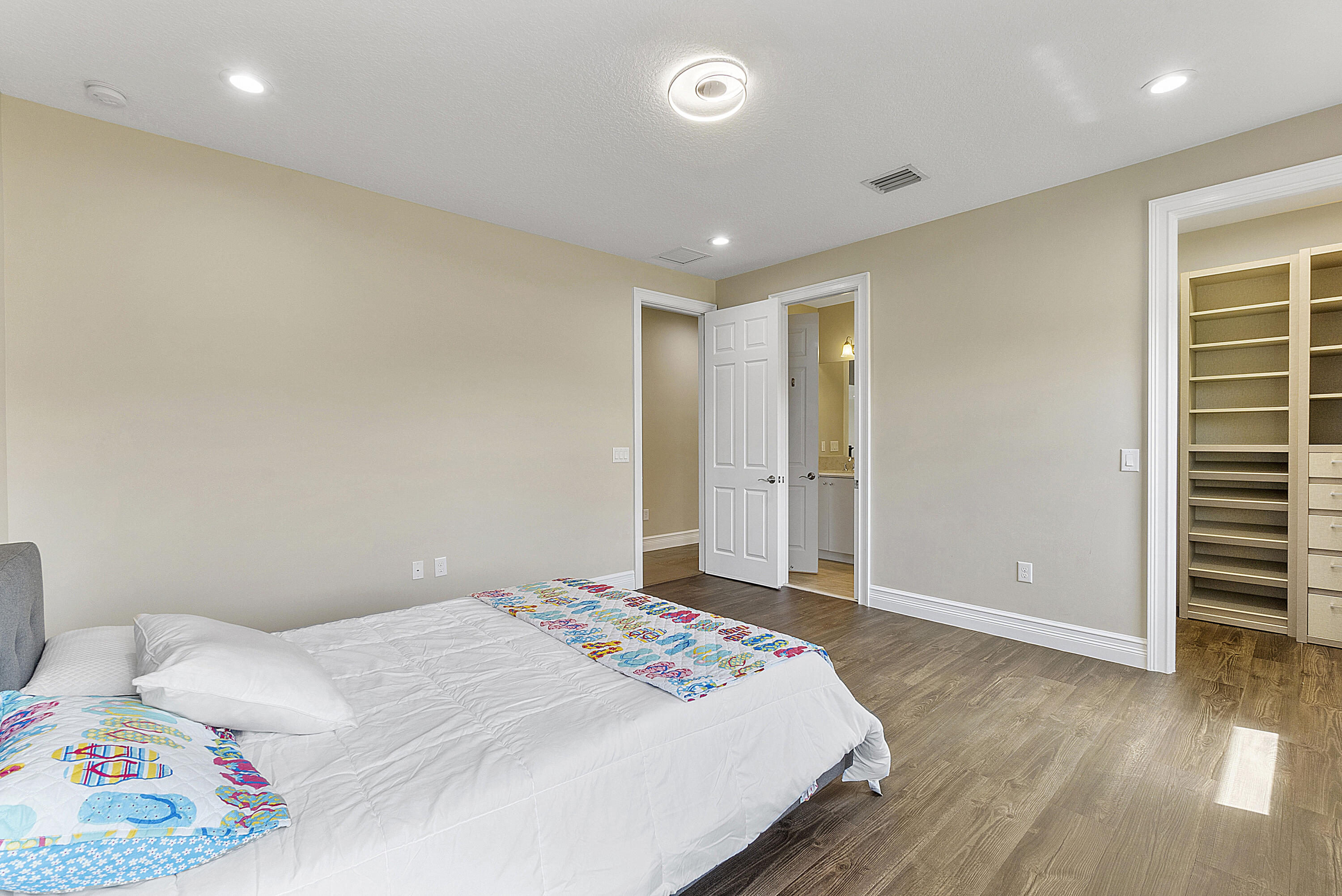 16897 Pierre Circle Delray Beach, FL 33446 - Photo 18 of 37 a bedroom with a bed and wooden floor