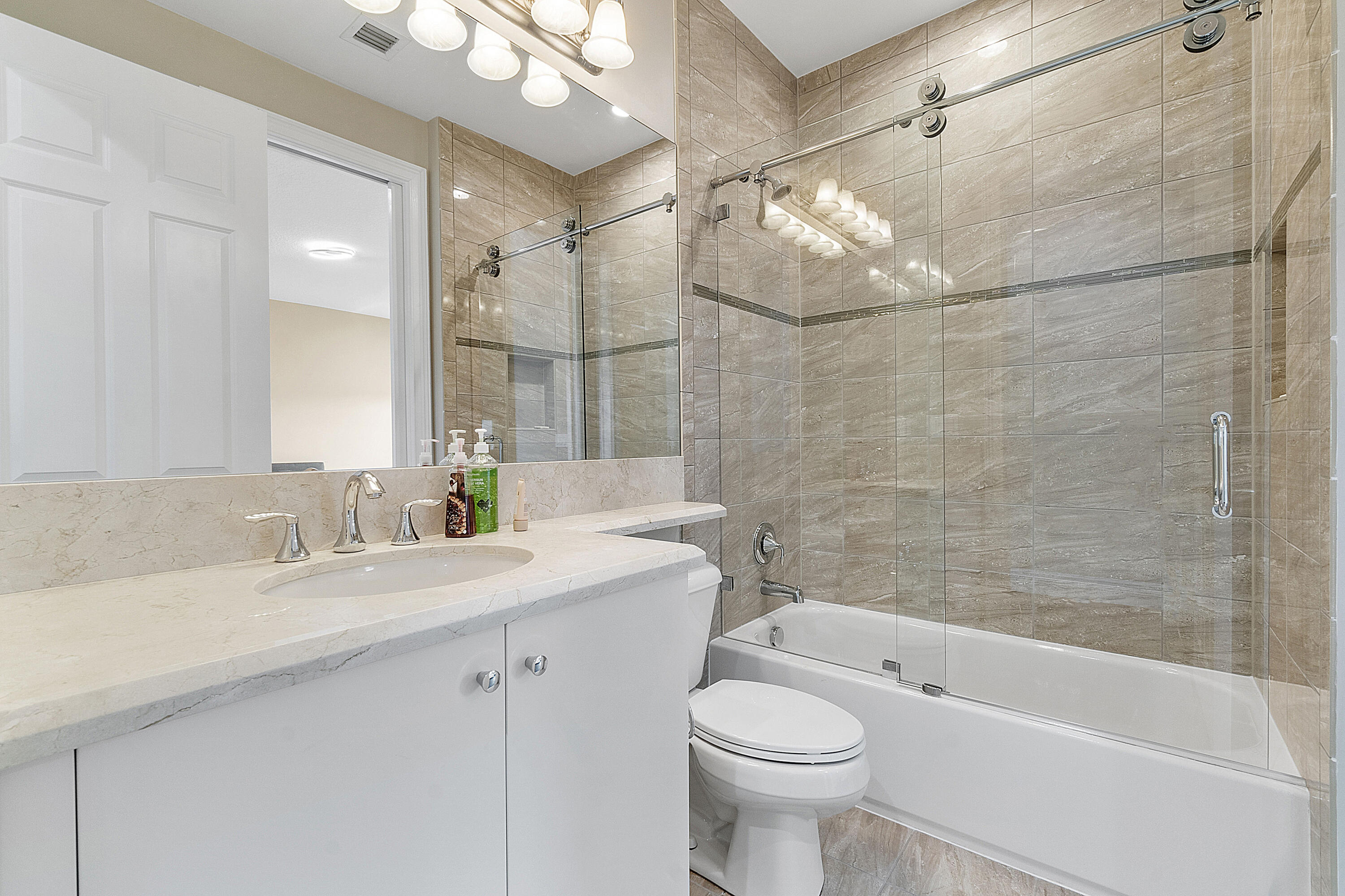 16897 Pierre Circle Delray Beach, FL 33446 - Photo 19 of 37 a bathroom with a sink a toilet and bathtub